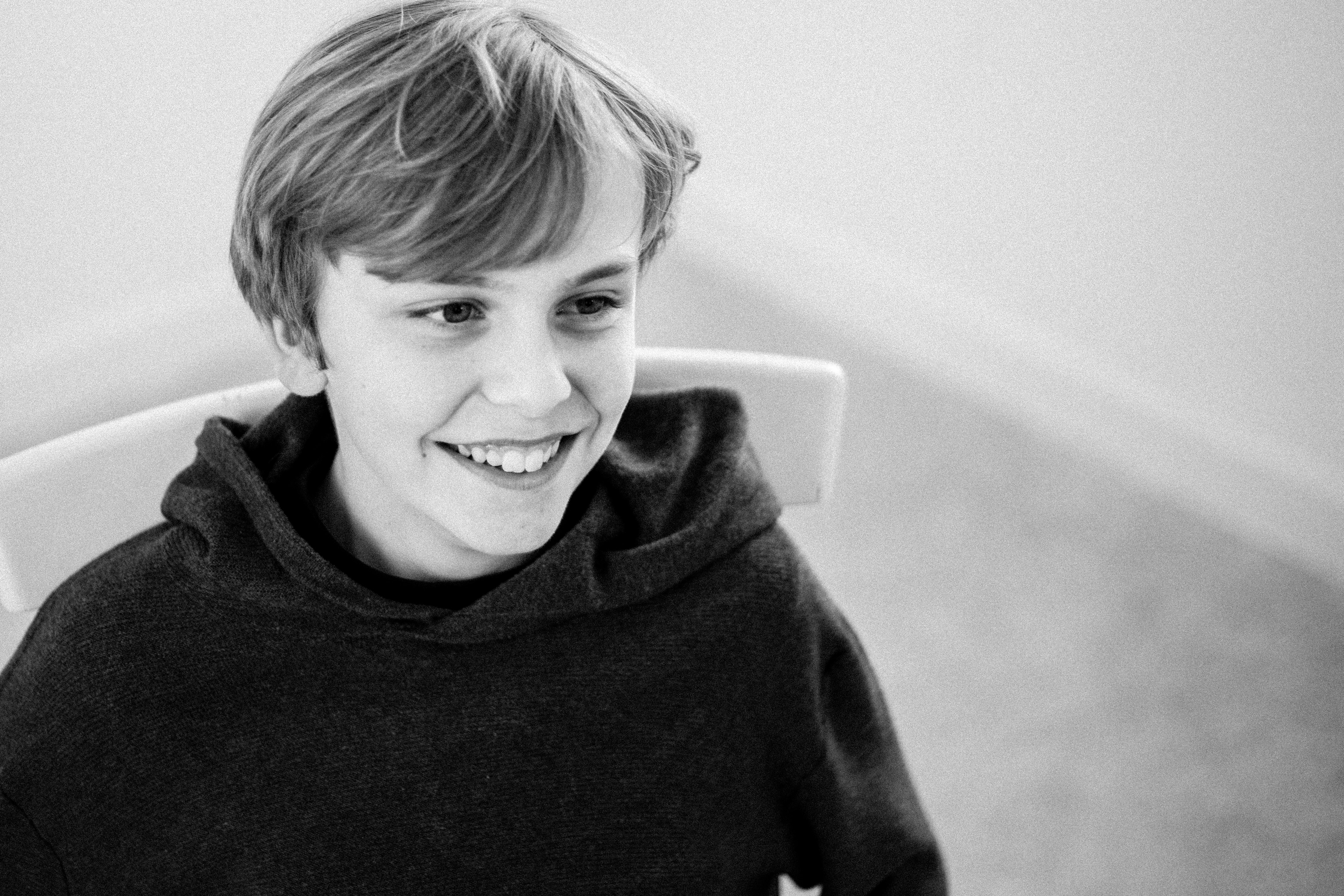 Black and white image of a young boy smiling