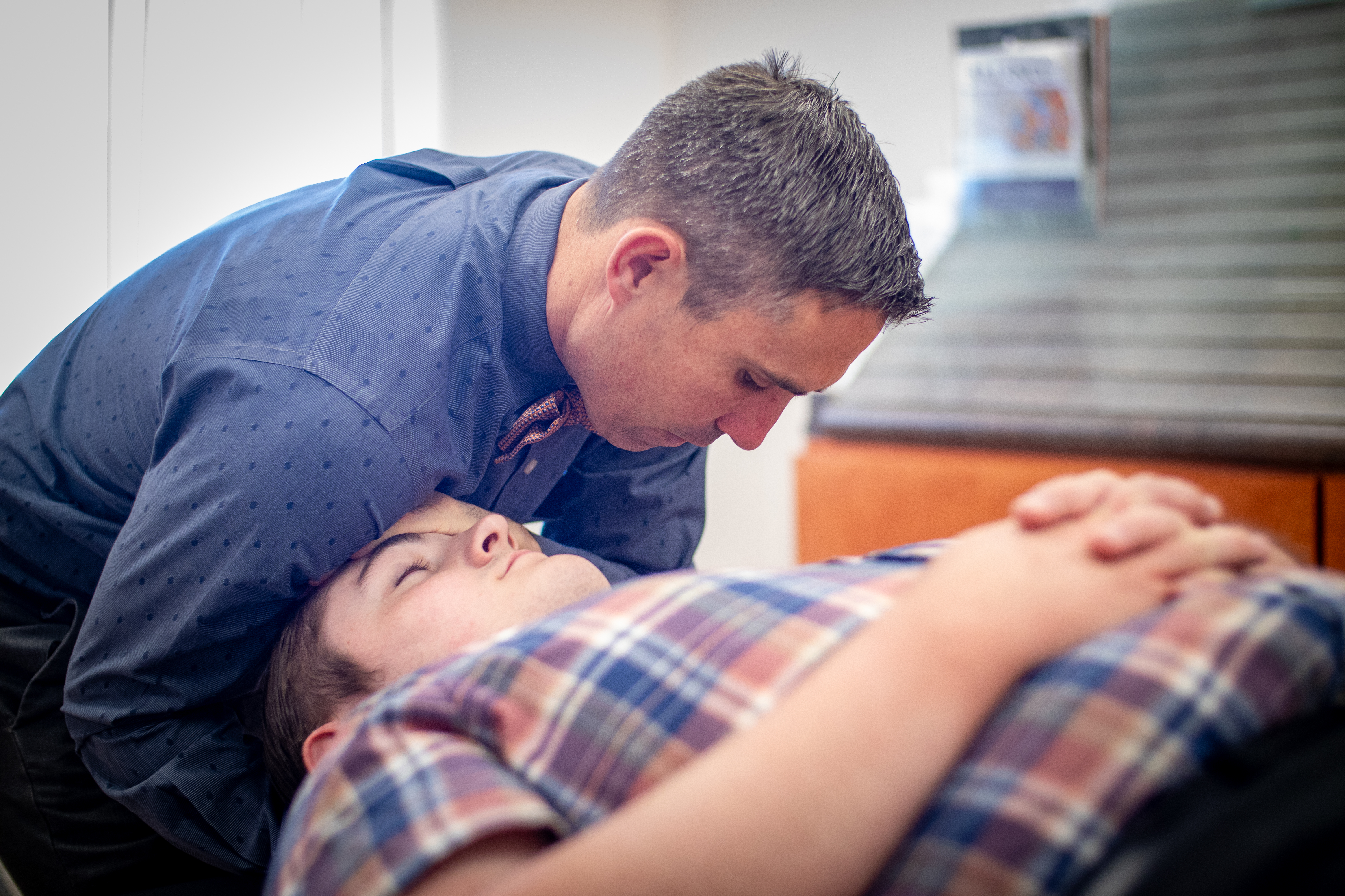 Physical therapist assessing a patient for TMD-related jaw dysfunction