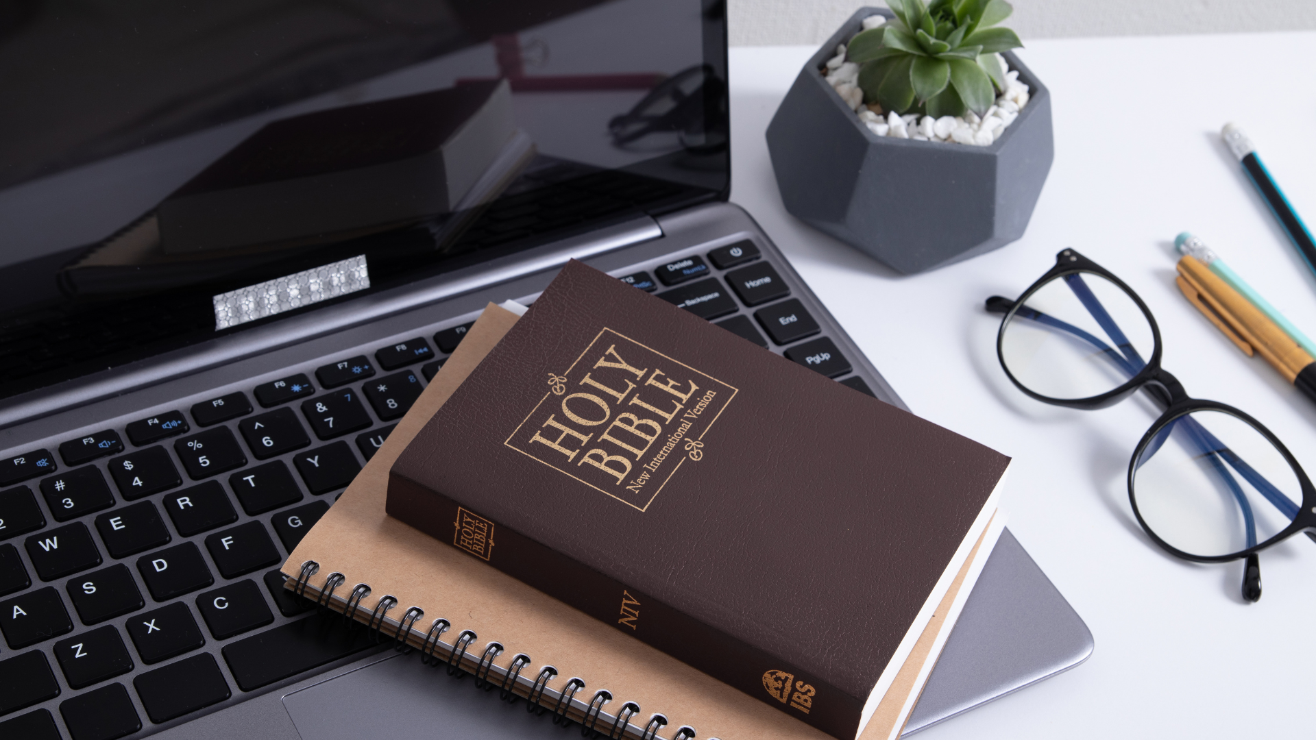 Laptop with Bible and Notebook