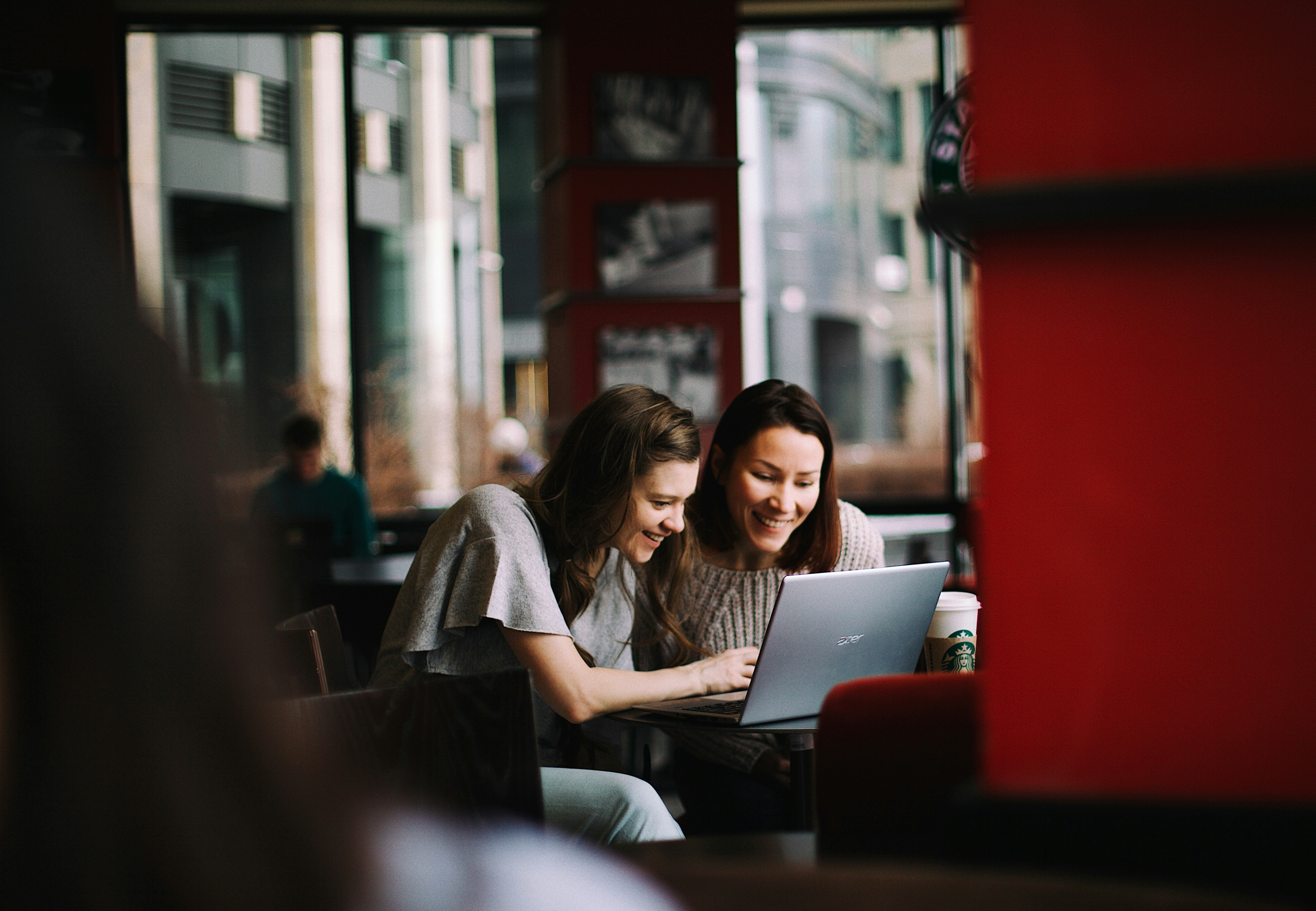 Two people sharing a laptop, illustrating discussion and reflection on priorities and what matters most.