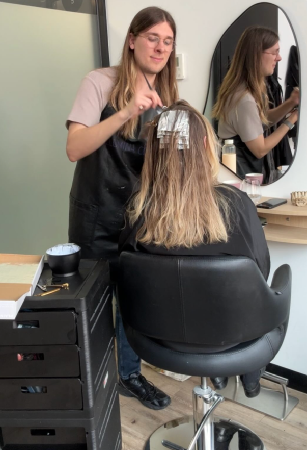 male hairdresser doing a clients hair 