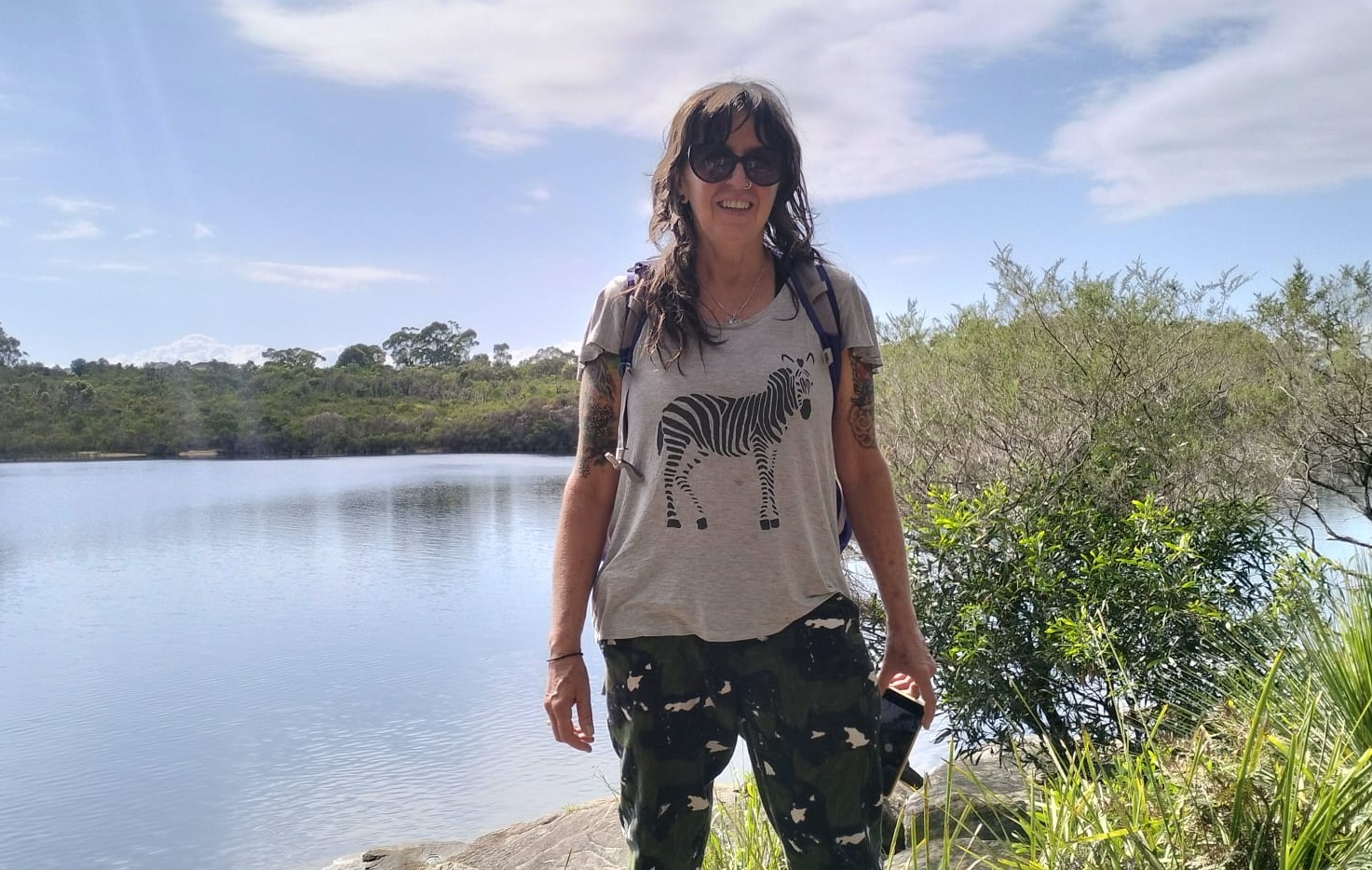 A yoga student stands in a Central American jungle clearing.