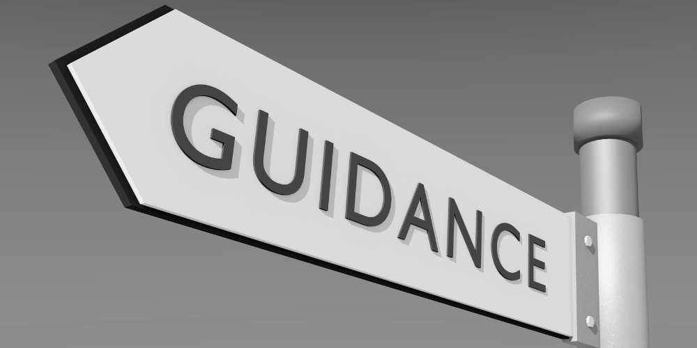Black and white photo of a street sign that says Guidance.