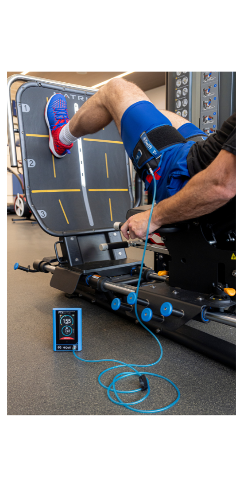 Athlete performing leg press with blood flow restriction (BFR) cuffs – strength training application