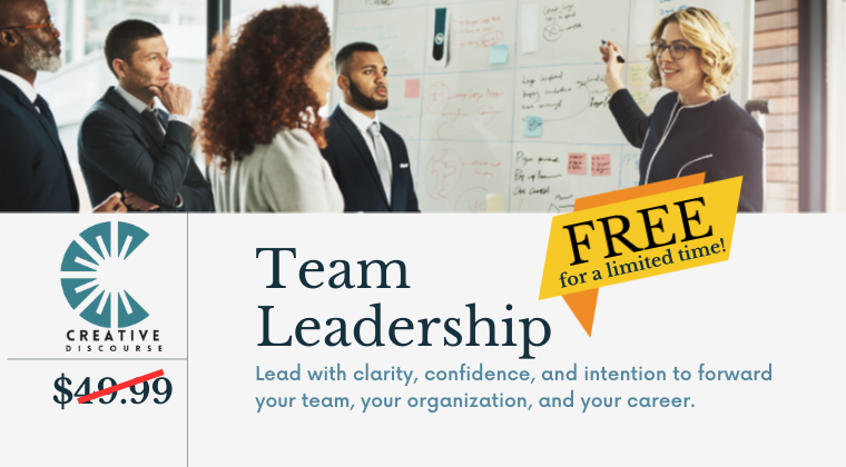 Group of professionals standing in line, smiling and chatting.