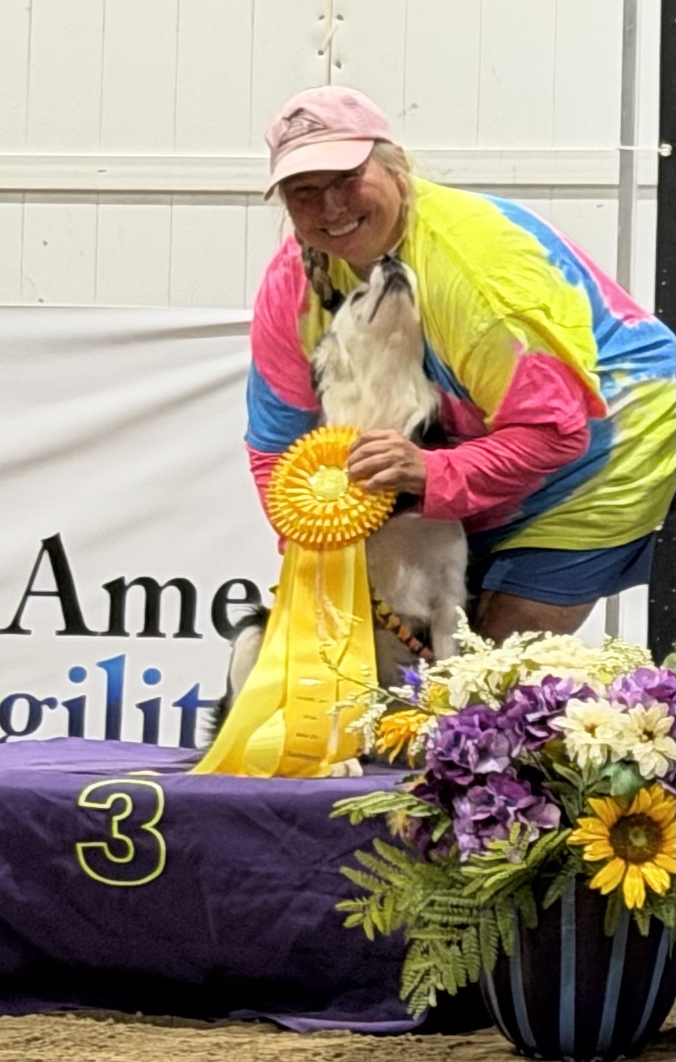 Myelin with her handler and third-place ribbon at the NADAC Championships.