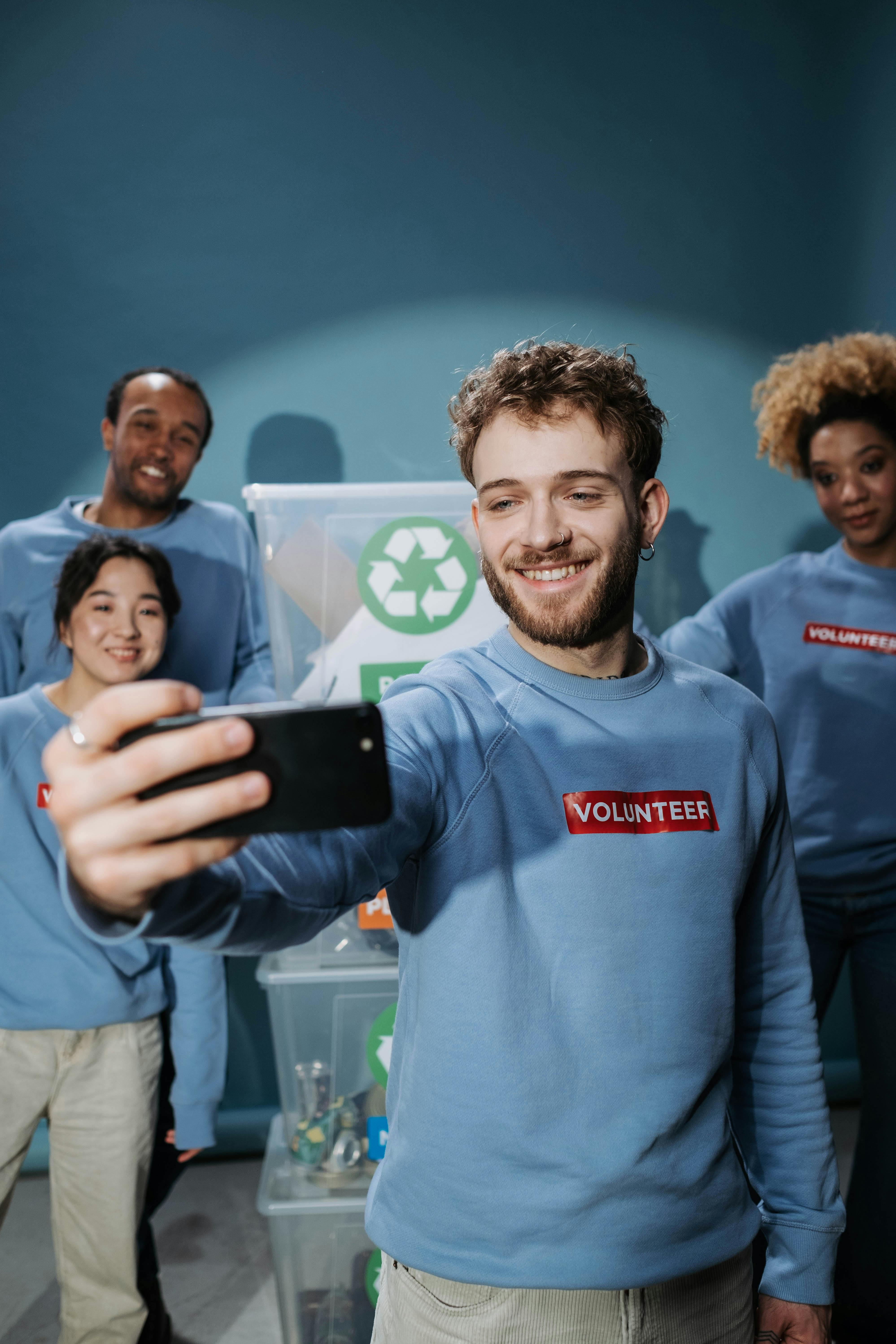 a team of volunteers poses for a group selfie