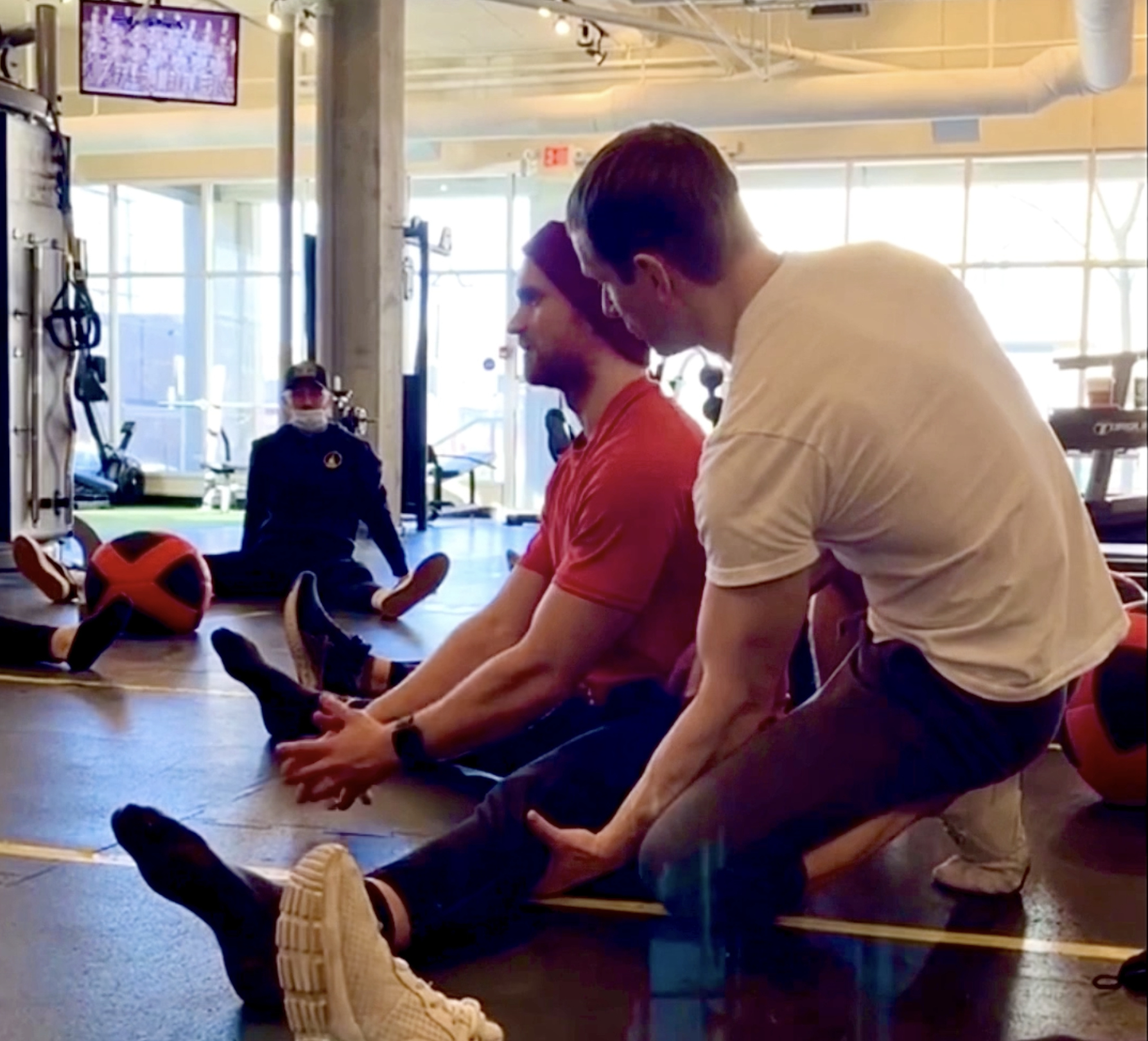 Trainer Maxim assisting a student with a drill