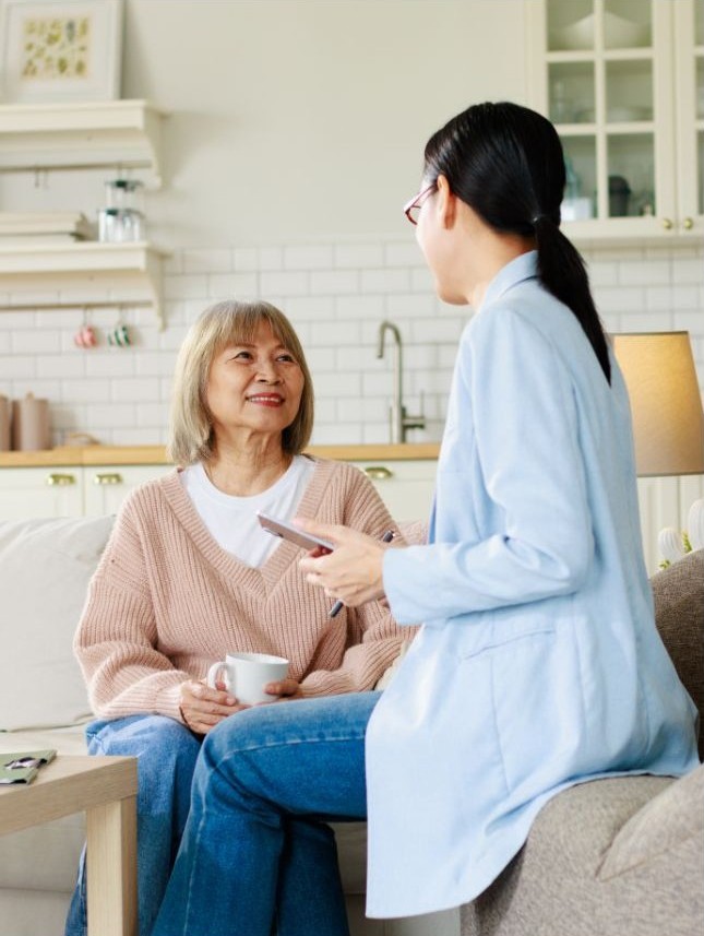 caregiver gently supporting an elderly person at home.