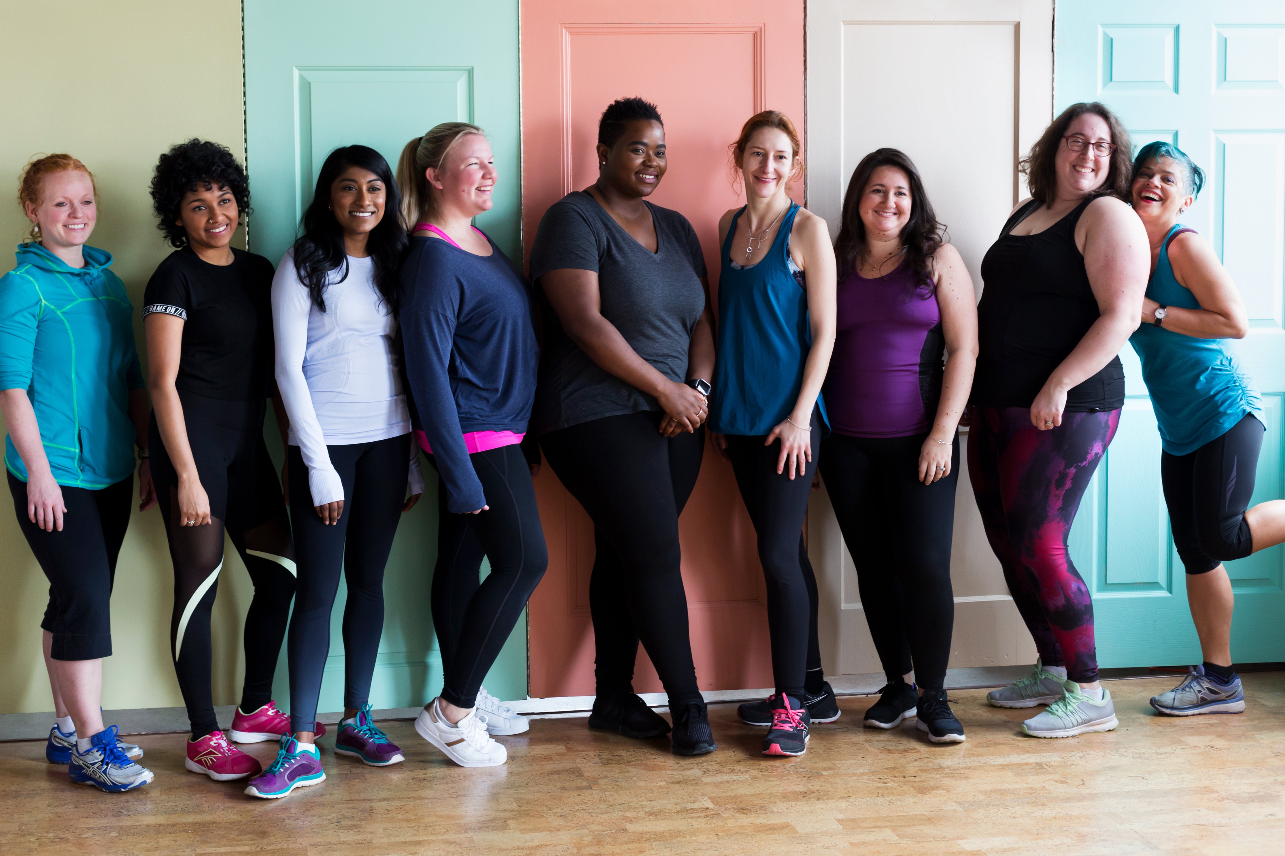 A group of smiling women standing together after a workout