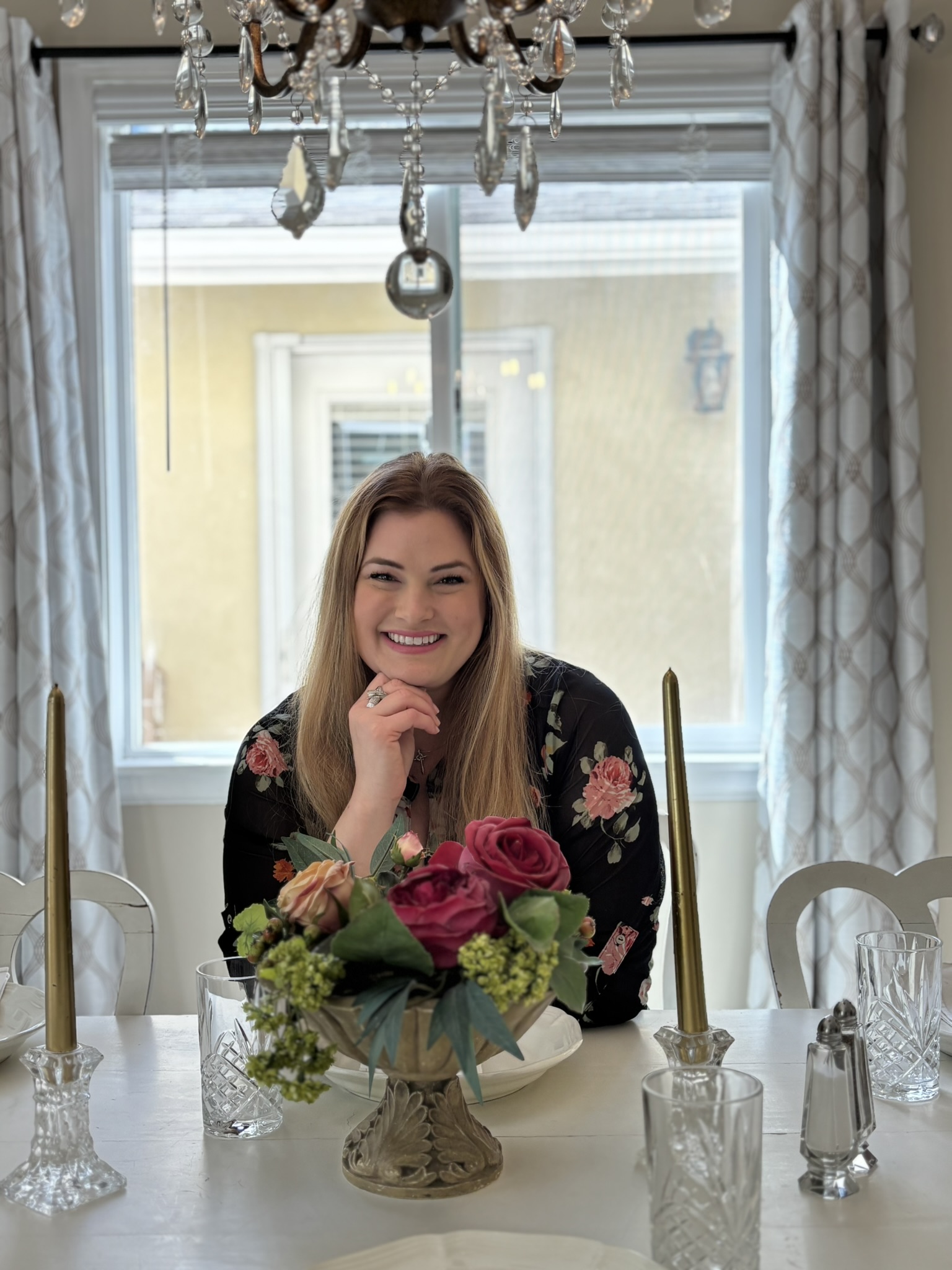 Gina Romero seated at a lovely dining table