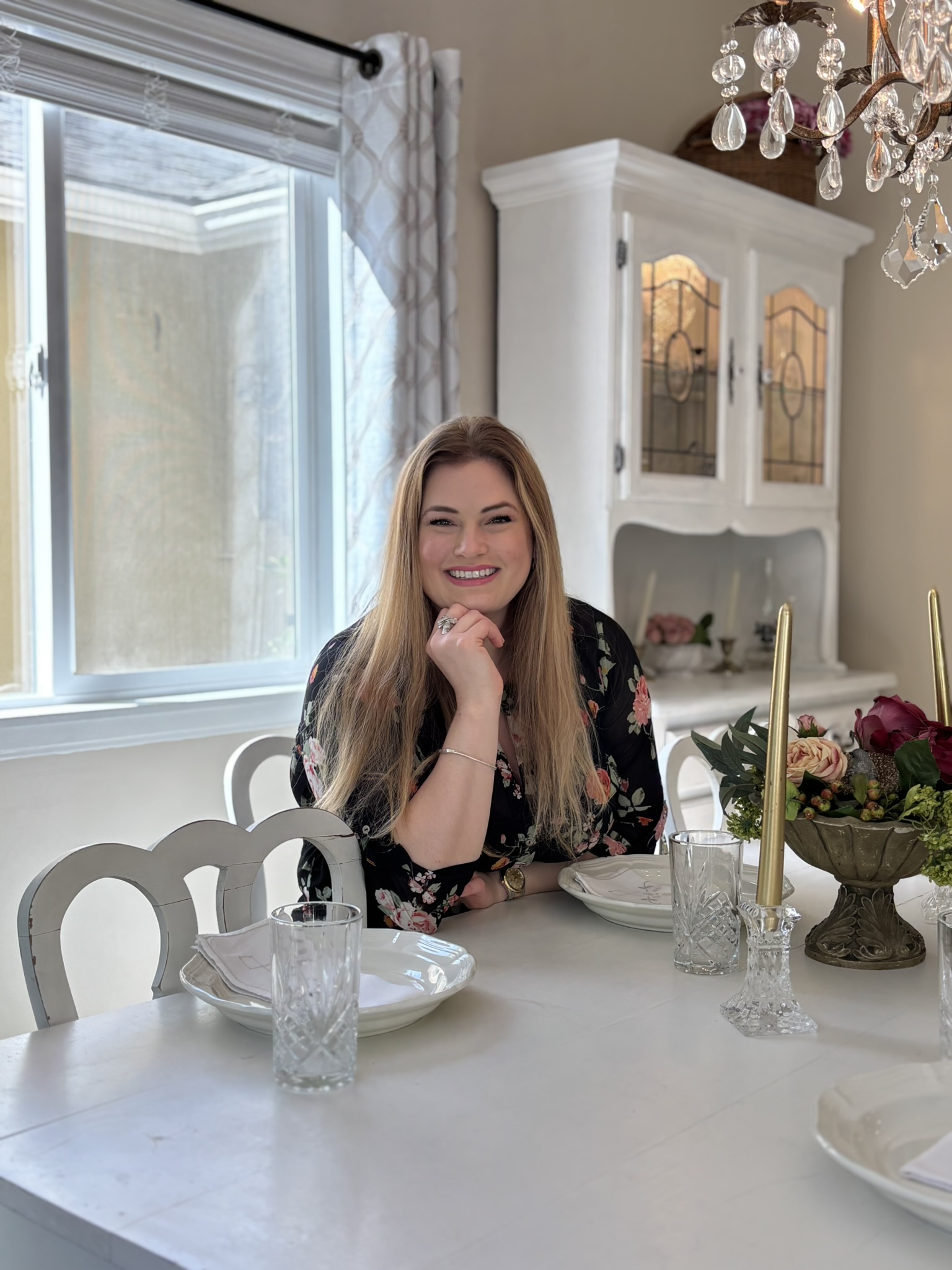 Gina Romero seated at a beautiful dining table