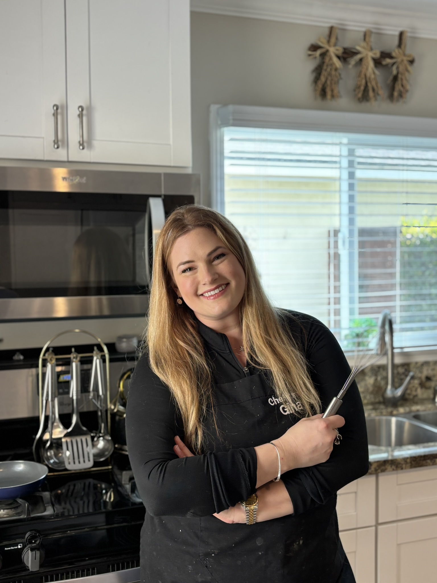 Gina Romero in a kitchen with a whisk