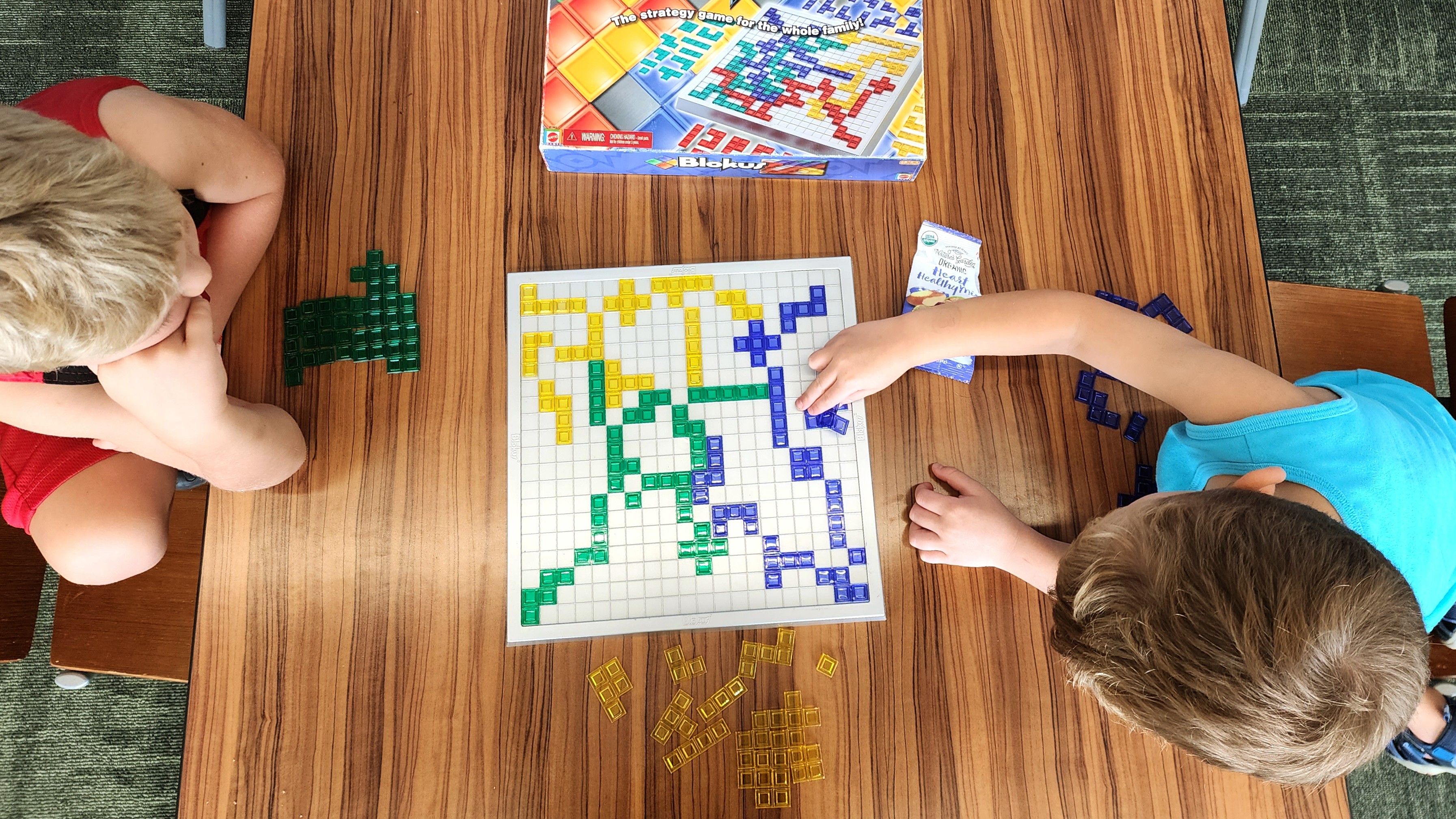 Kids playing the game blokus