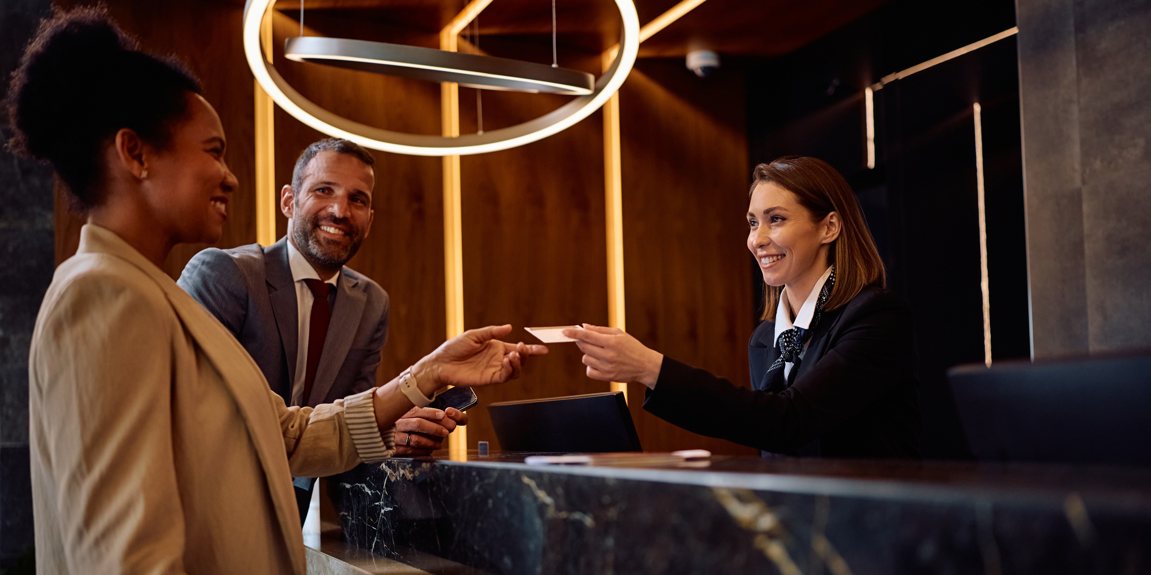 Hotel reception team welcoming guests in a luxury hospitality environment