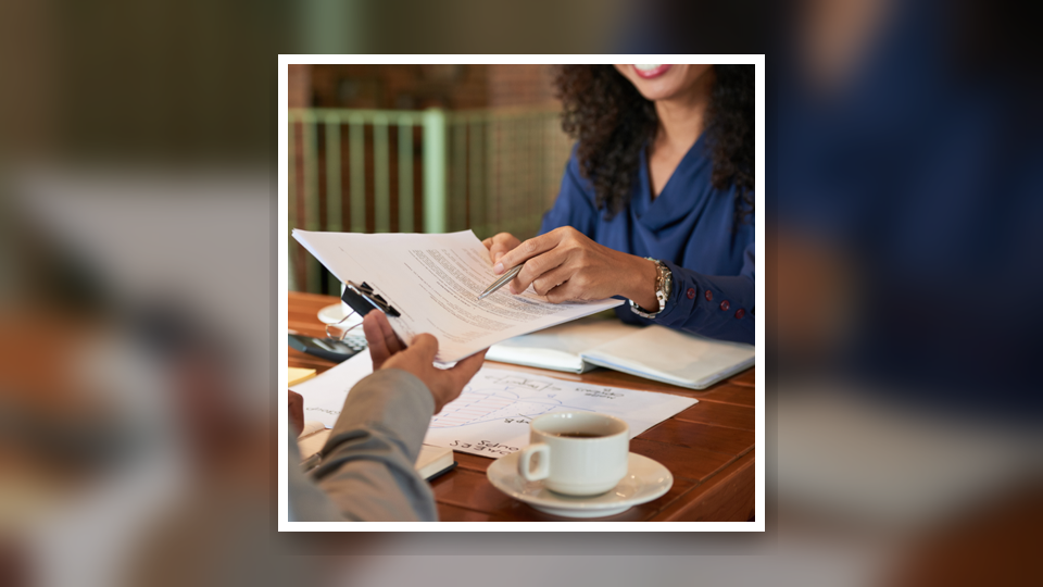 Attorney reviewing documents across a desk