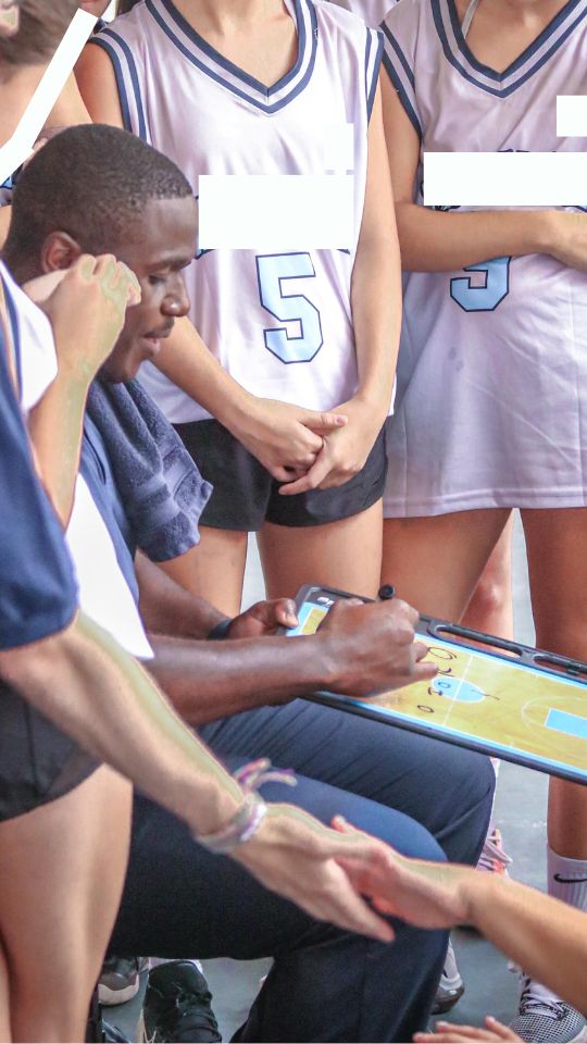 coach darren davy drawing on clipboard coaching girls basketball