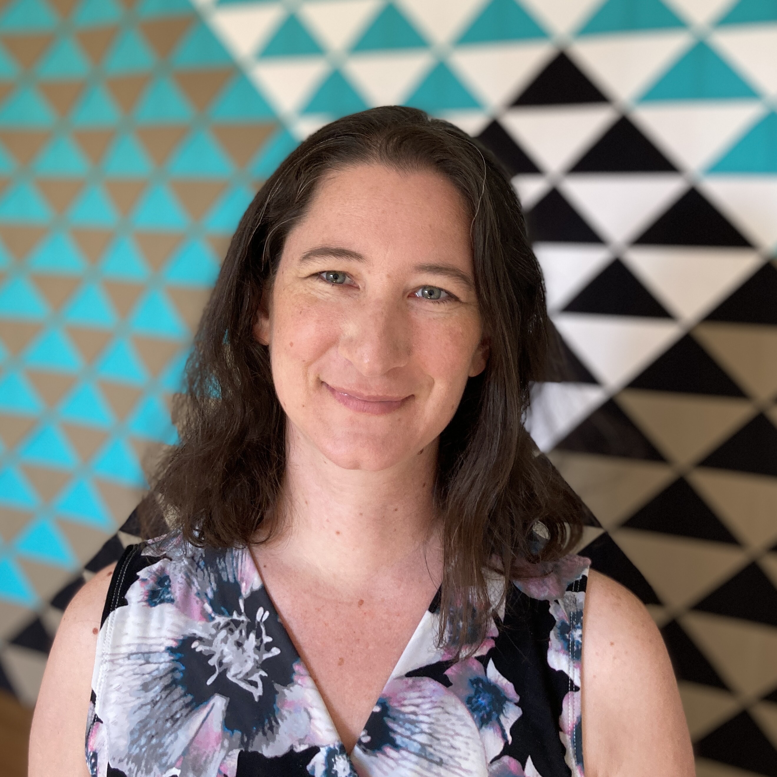 Karen Bolan in front of her Folded Flyers quilt
