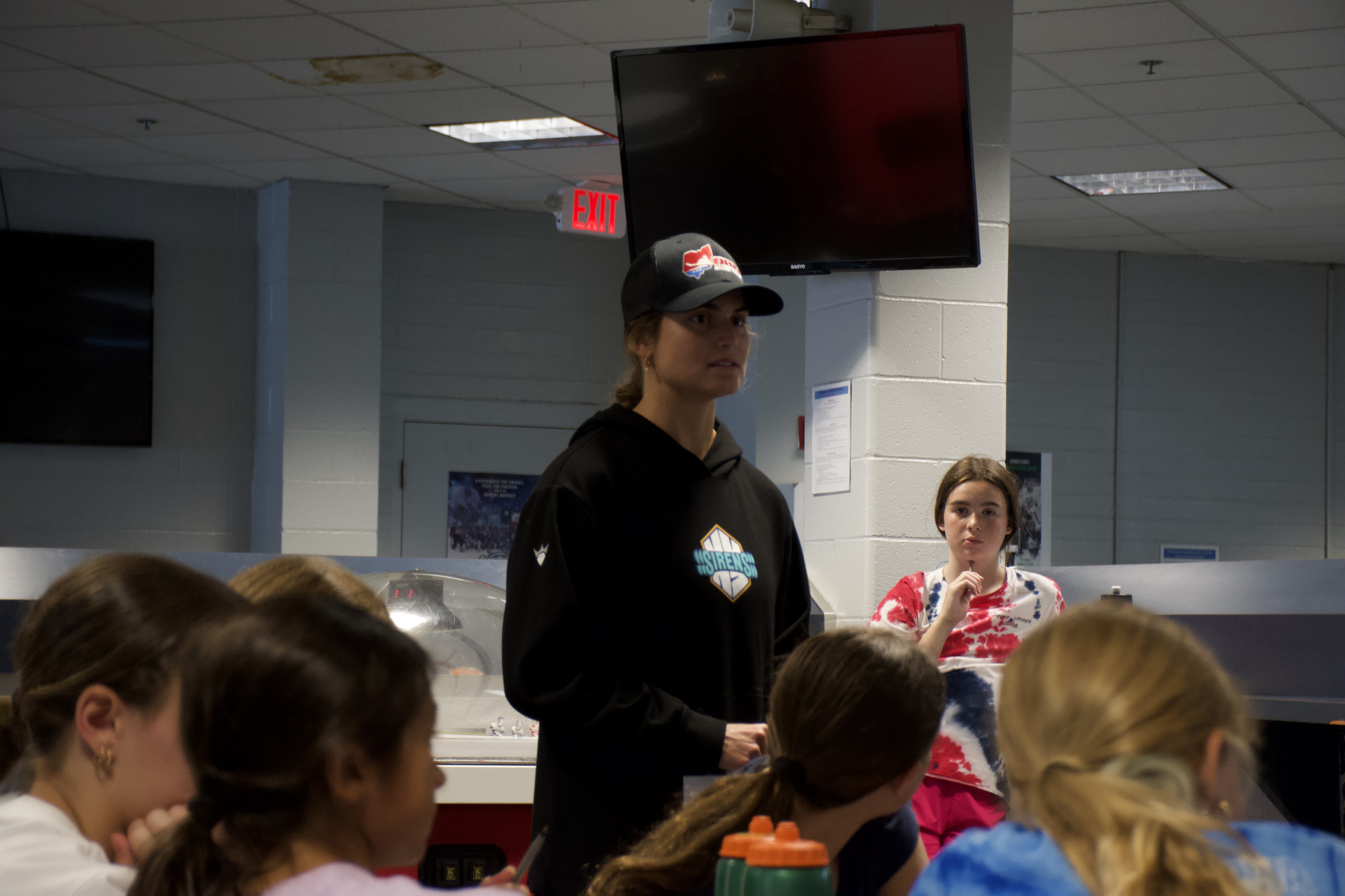 An OHP coach talking with a group of young players
