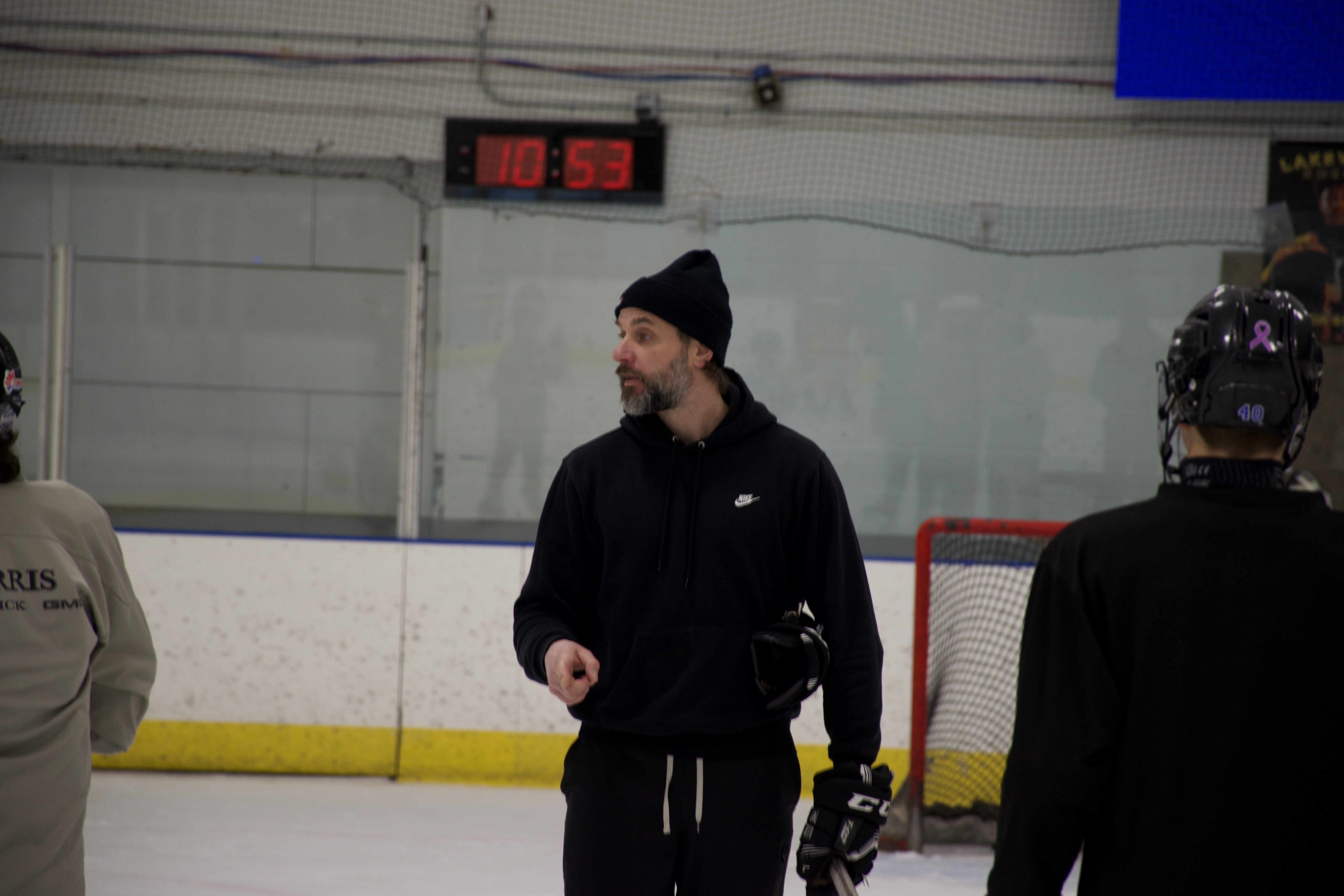 An OHP coach working with players at the rink
