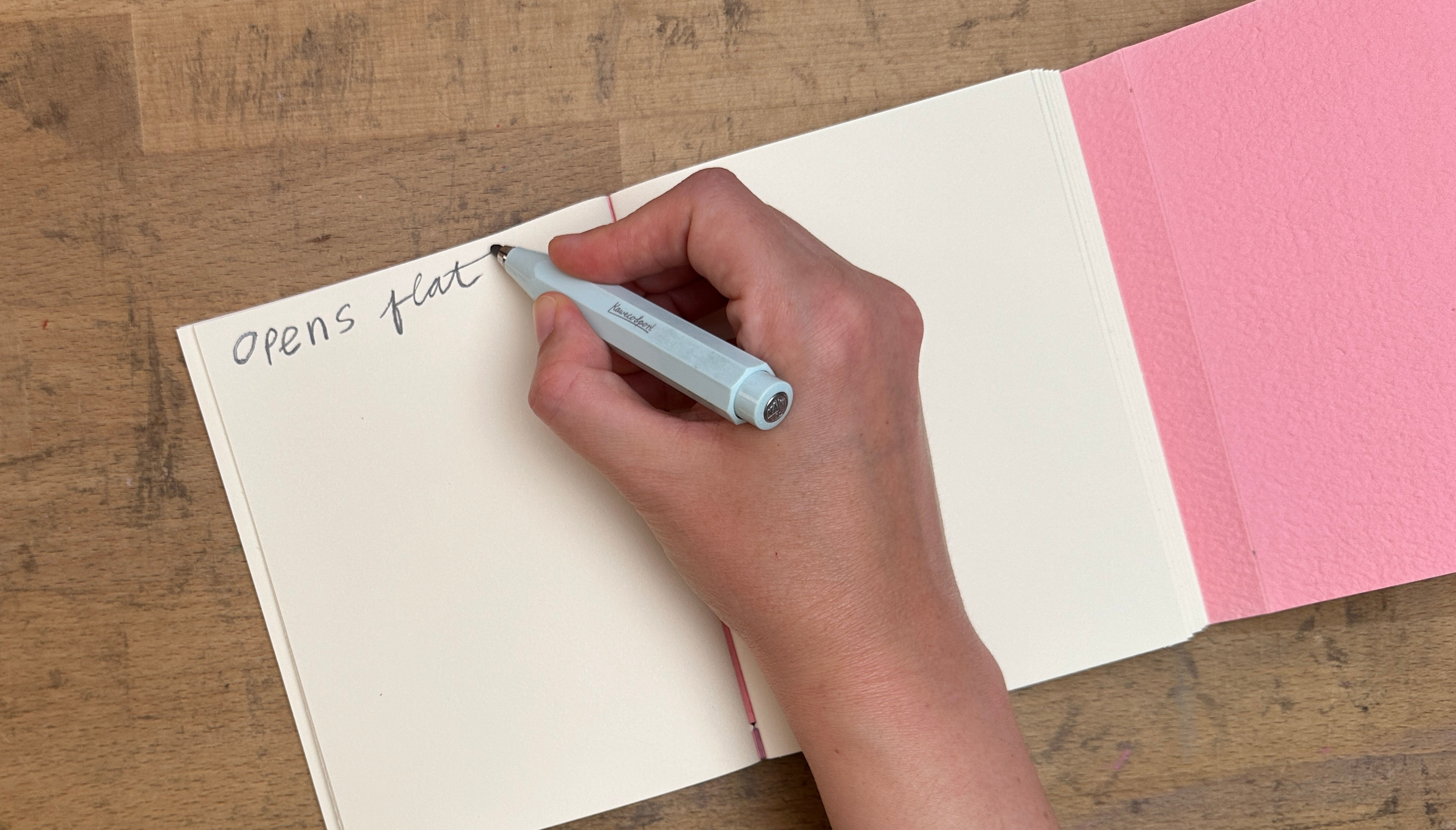Writing 'opens flat' in pencil to showcase the flexibility of the binding.