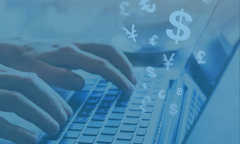Hands on keyboard with money symbols