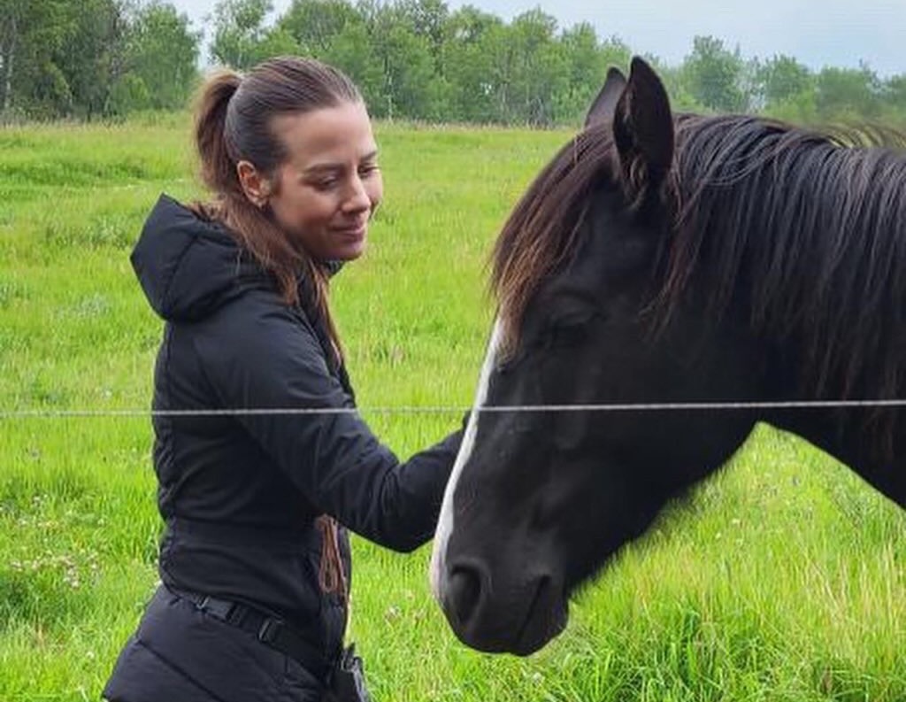 A woman with her horse in a soft connected moment
