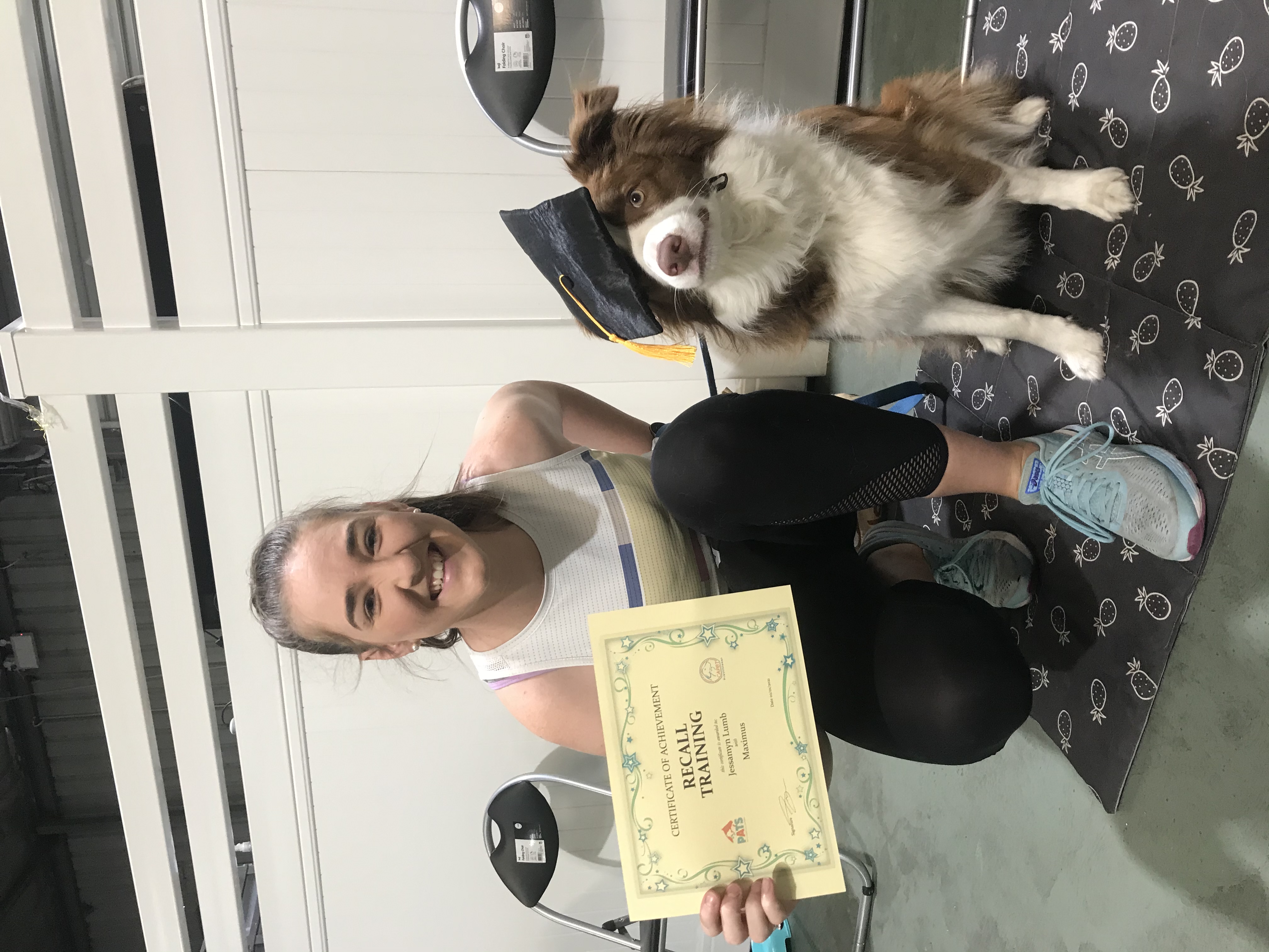 Border collie with owner after graduating recall training