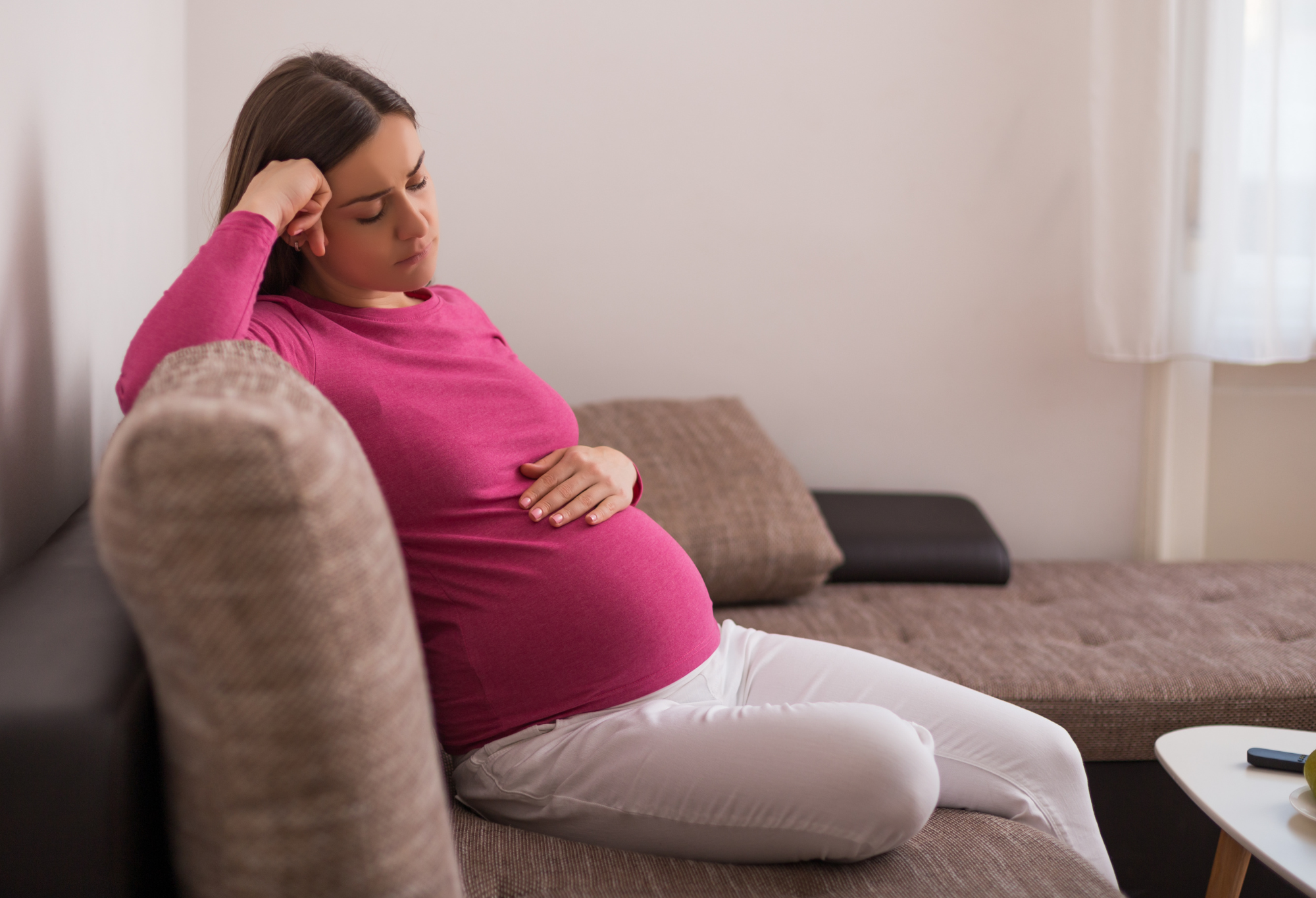 pregnant woman looking down. 