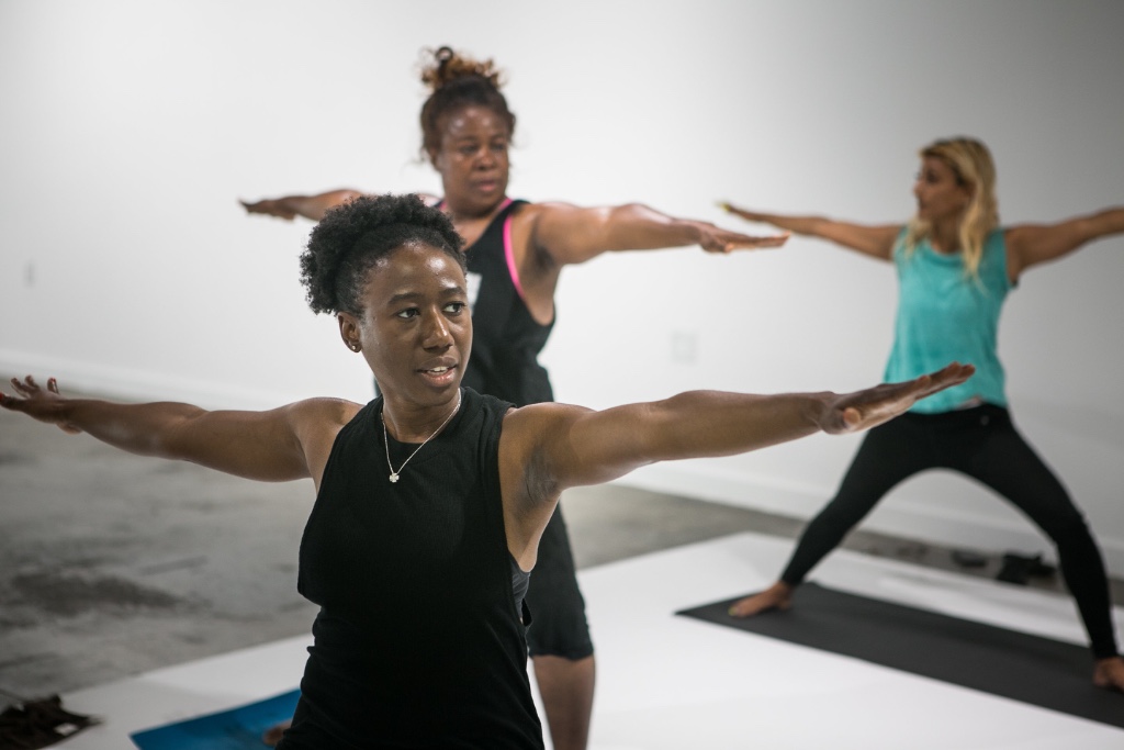 Ivory Howard leads a power yoga class.