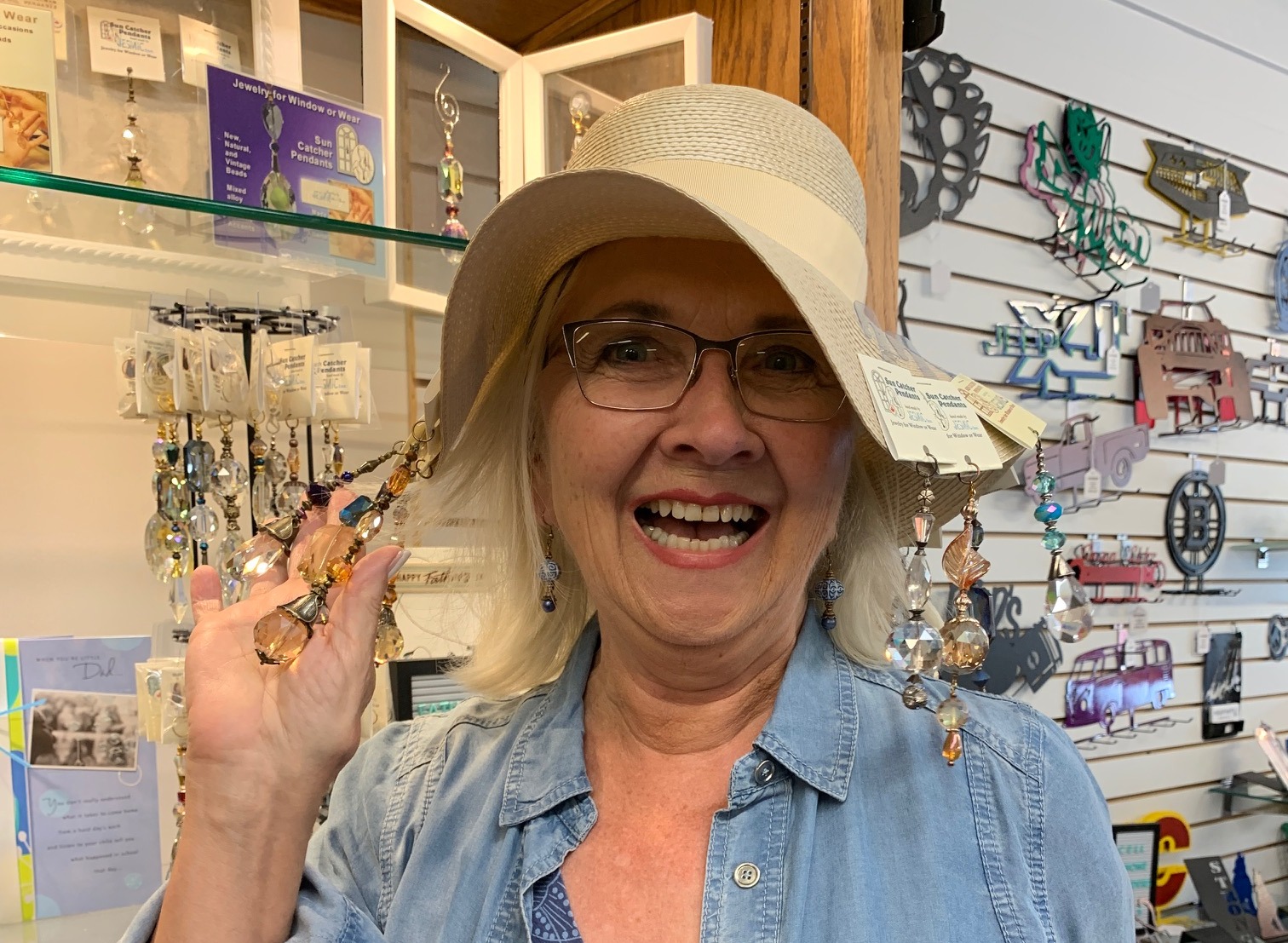 Linda with Sun Catcher Pendants on her had for a community side walk sale. They sparkled in the sun!