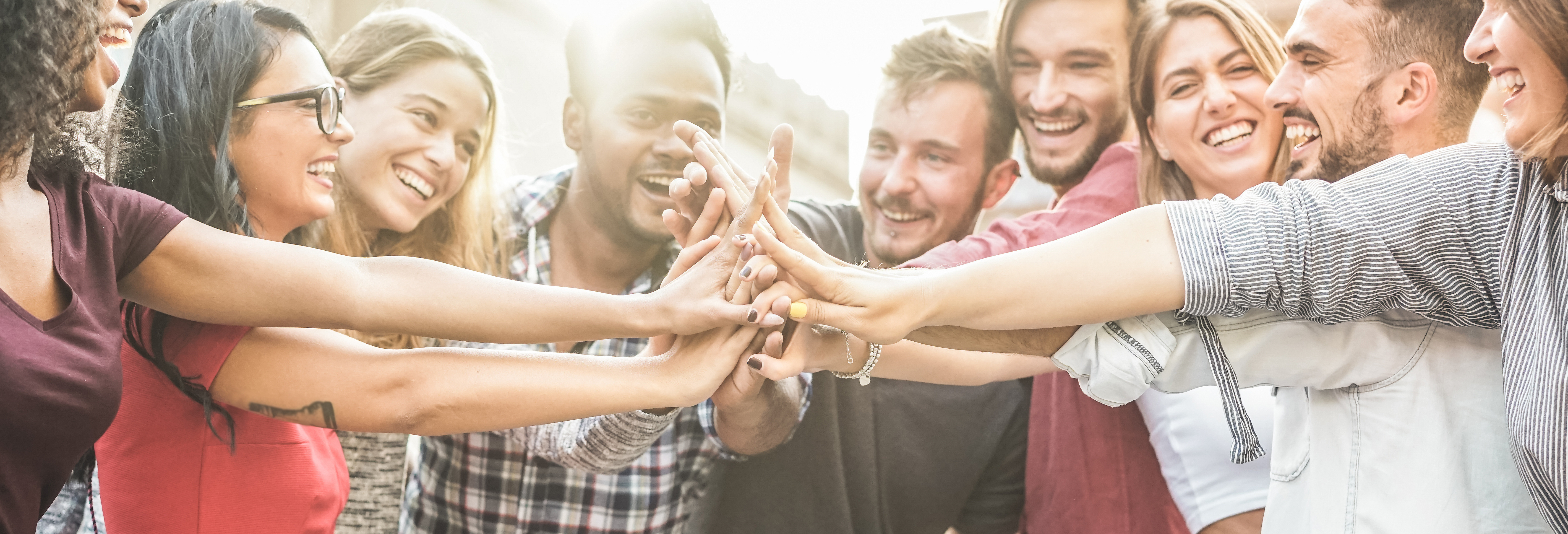 Friend smiling and touching hands in the center of a circle. Friend smiling and touching hands in the center of a circle.
