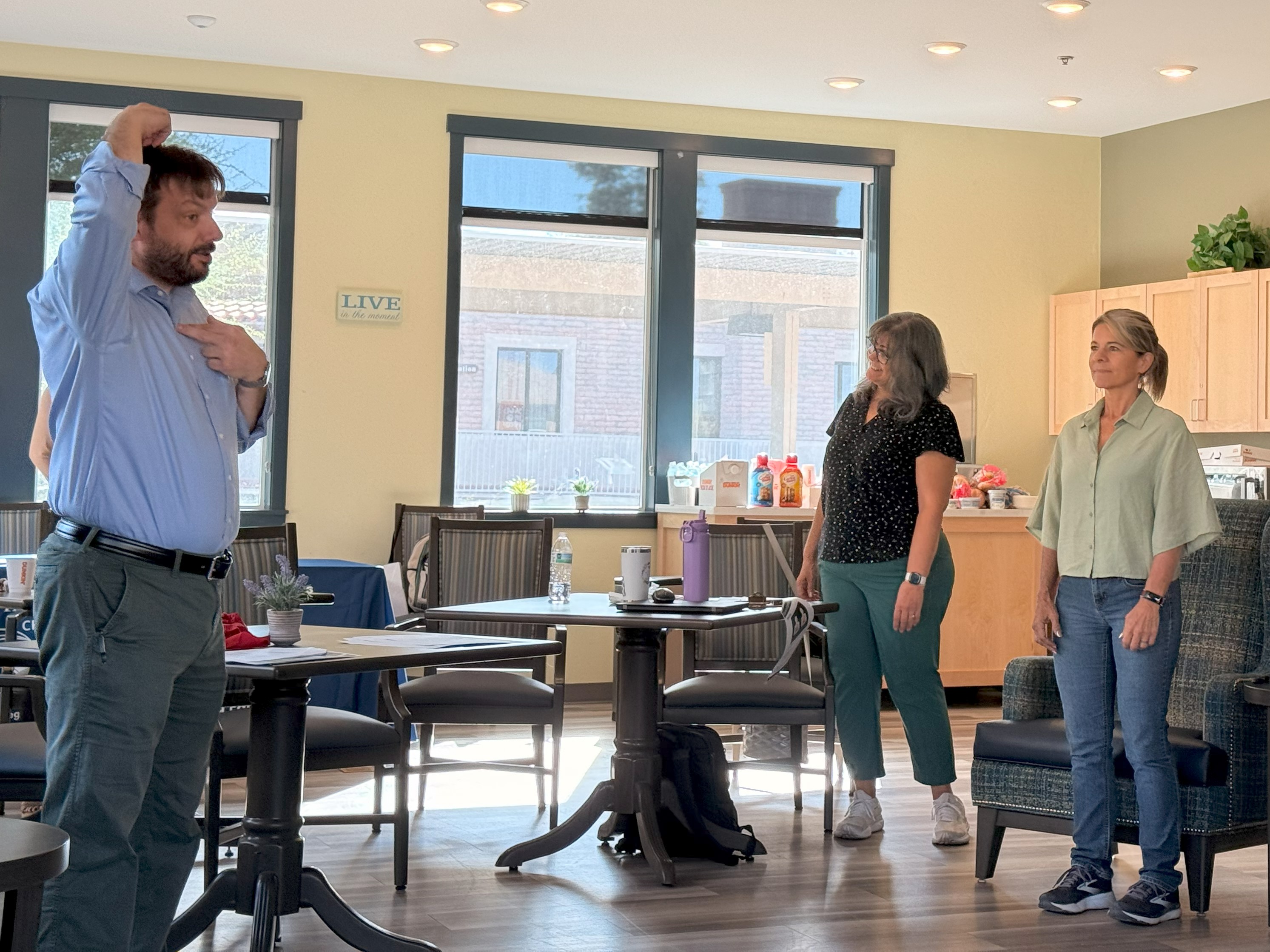 Ben showing how to find proper posture in a classroom setting