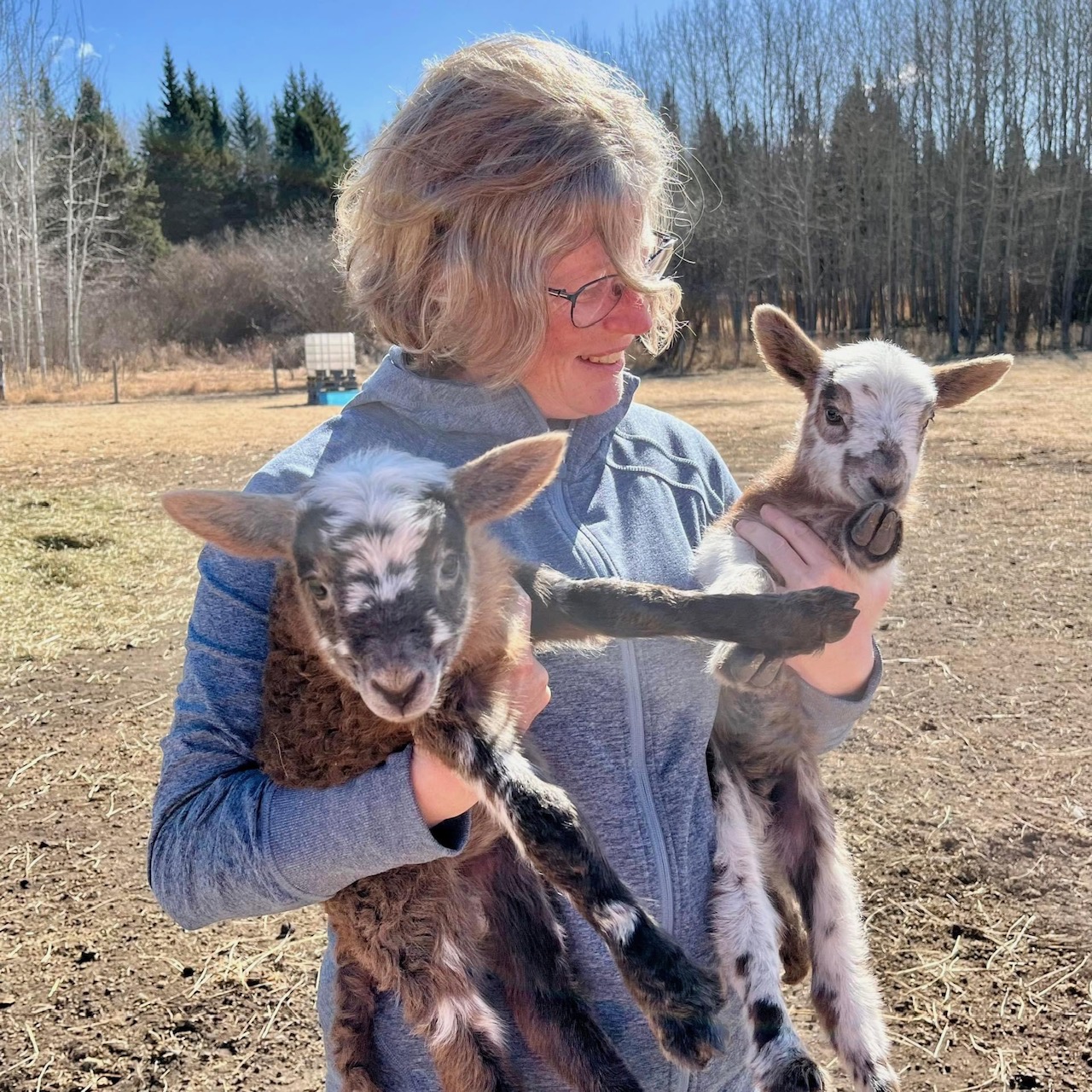 Lisa Wright holding two lambs