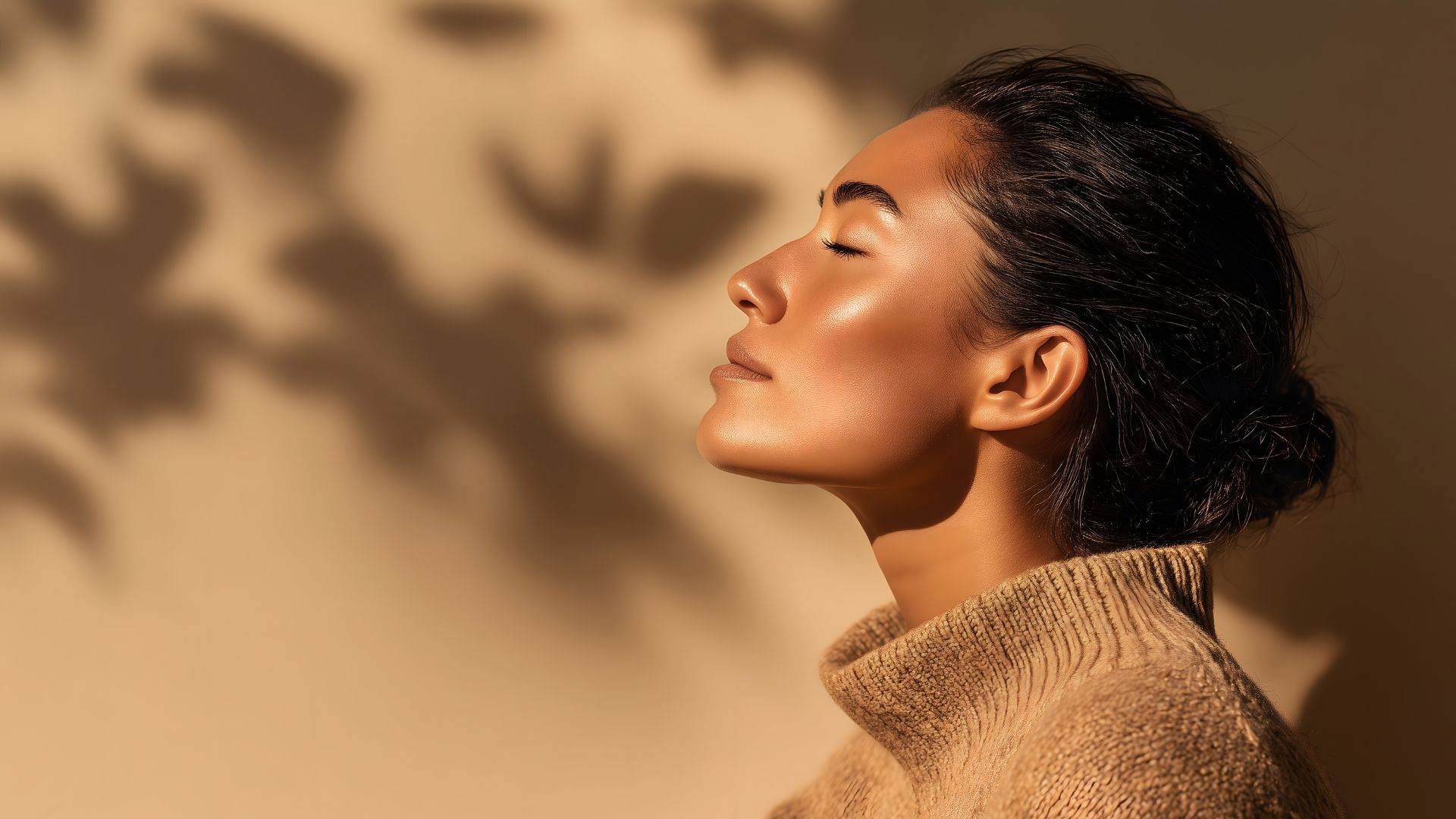 Woman bathed in warm sunlight, embodying feminine power and cyclical awareness.