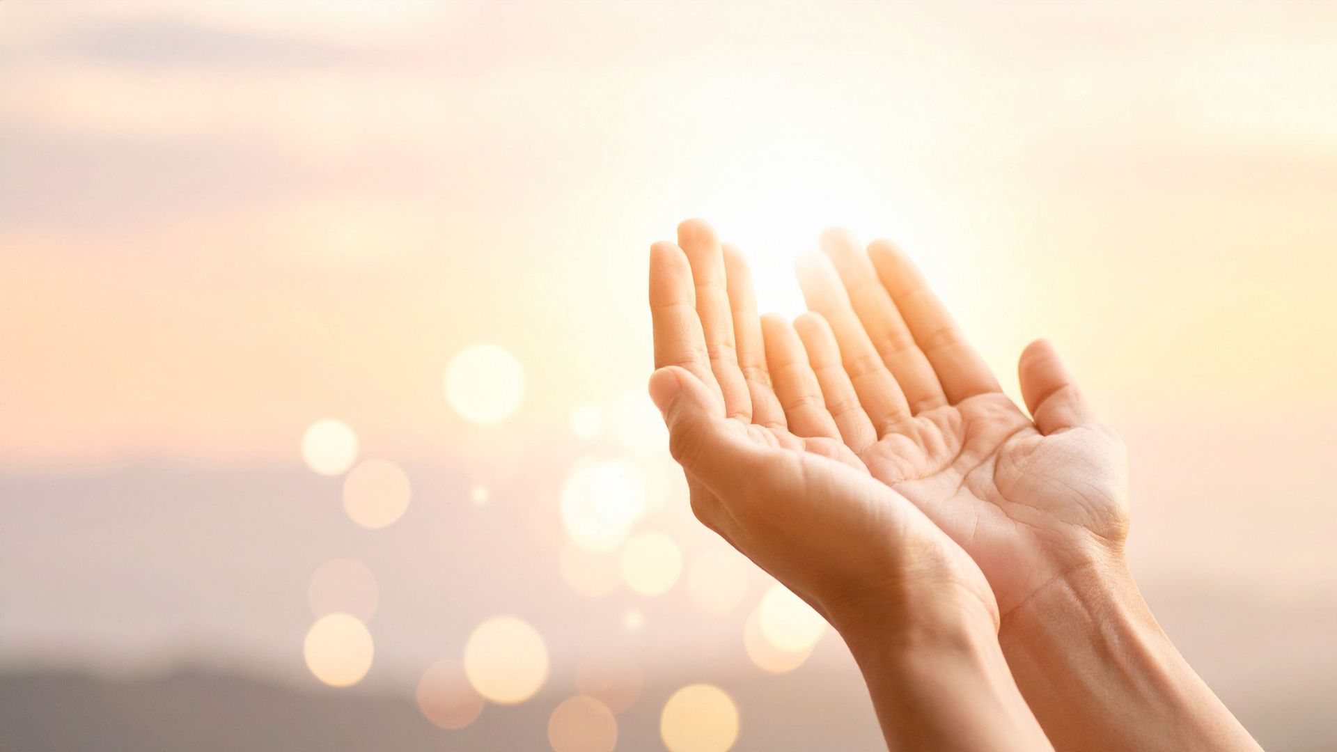 Open hands receiving soft golden light, representing intention and inner alignment.