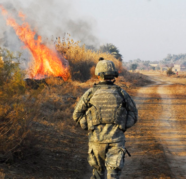 A soldier walking down a road