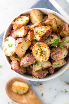 Easy side dish recipe for crispy garlic roasted potatoes cooked on a baking sheet and seasoned with rosemary and oil for extra flavor.