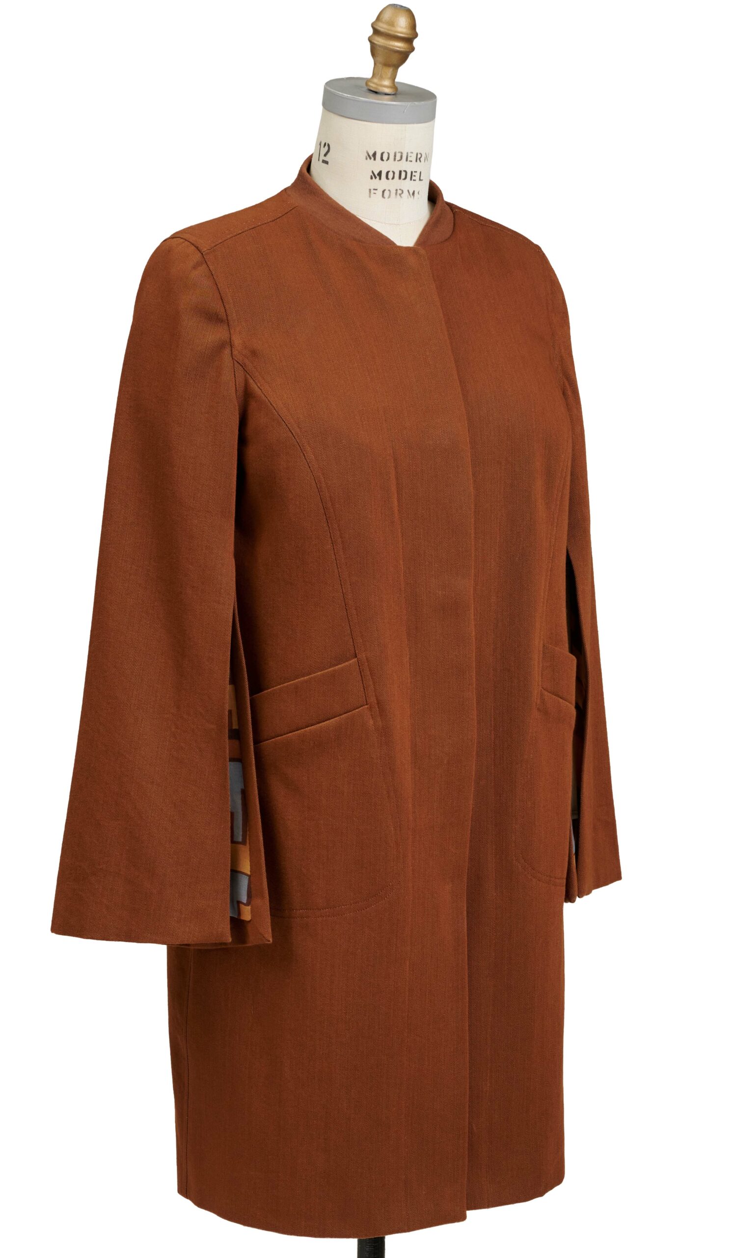 Brown coat on a dress form with hidden buttoning down the center front