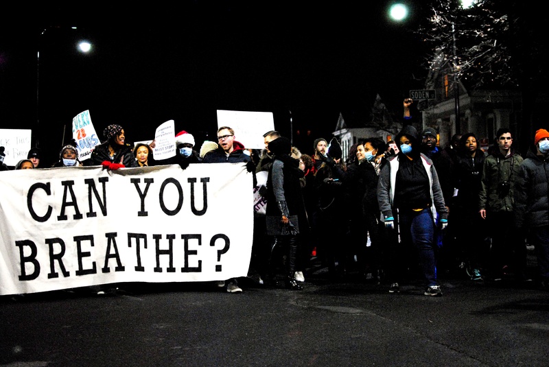 Protests march up shouting "We Can't Breathe"