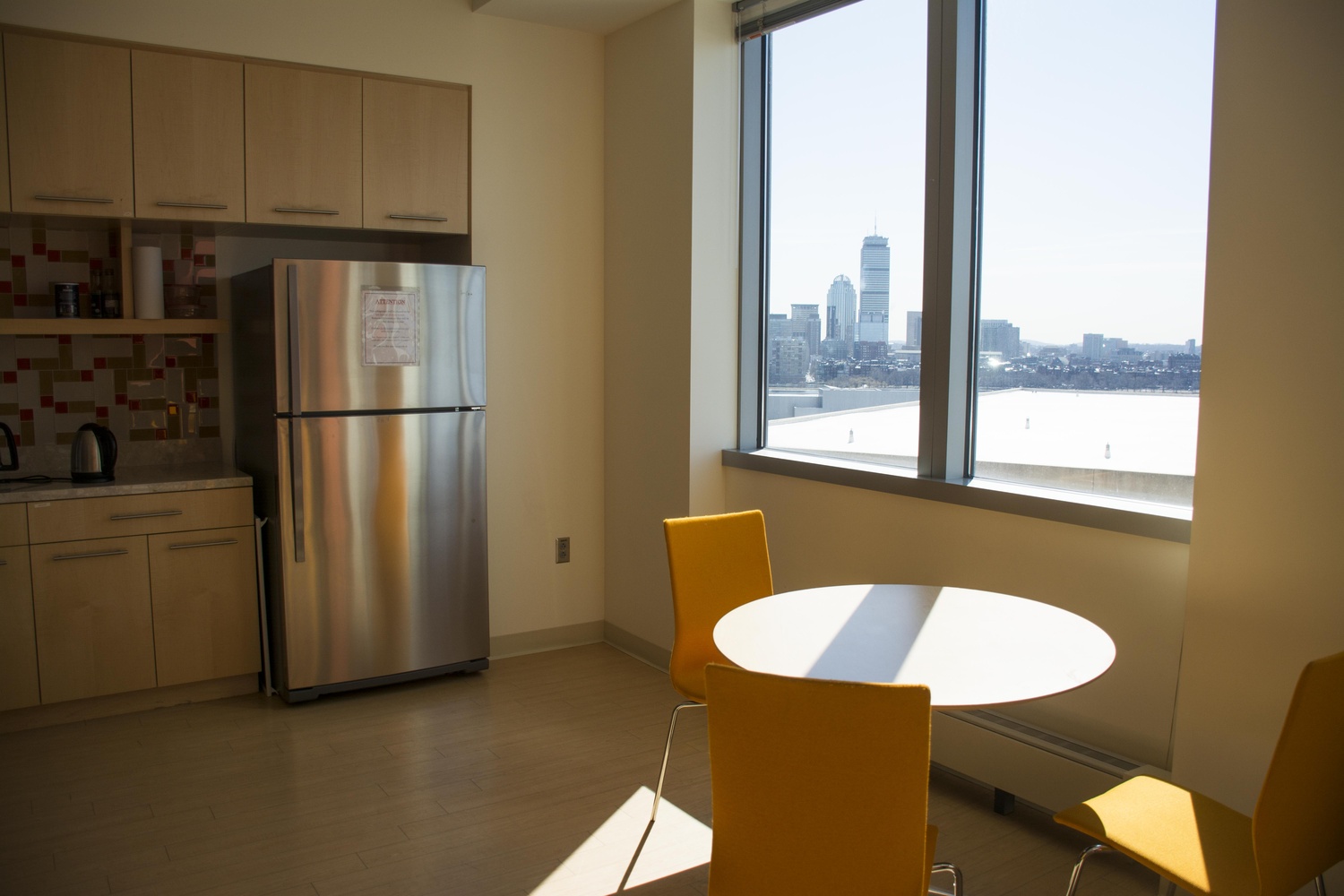 The kitchen where Zhang and his team eat their takeout meals has broad views of the Boston skyline. 