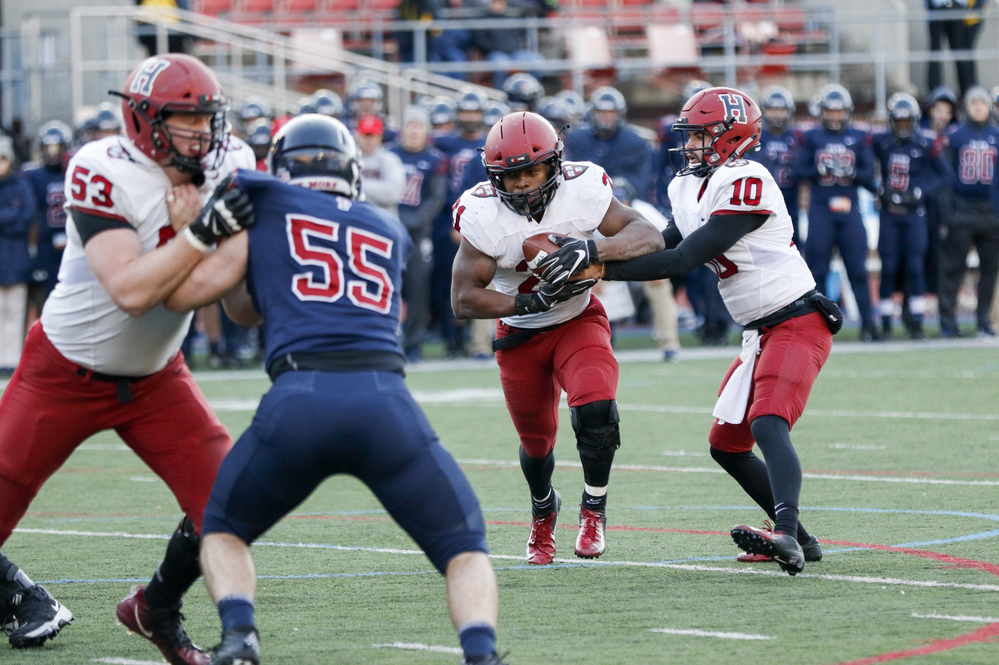Senior running back Charlie Booker takes the handoff from sophomore quarterback Jake Smith. Booker was good for 74 yards and one touchdown in Harvard's ground-game dominance over Penn.