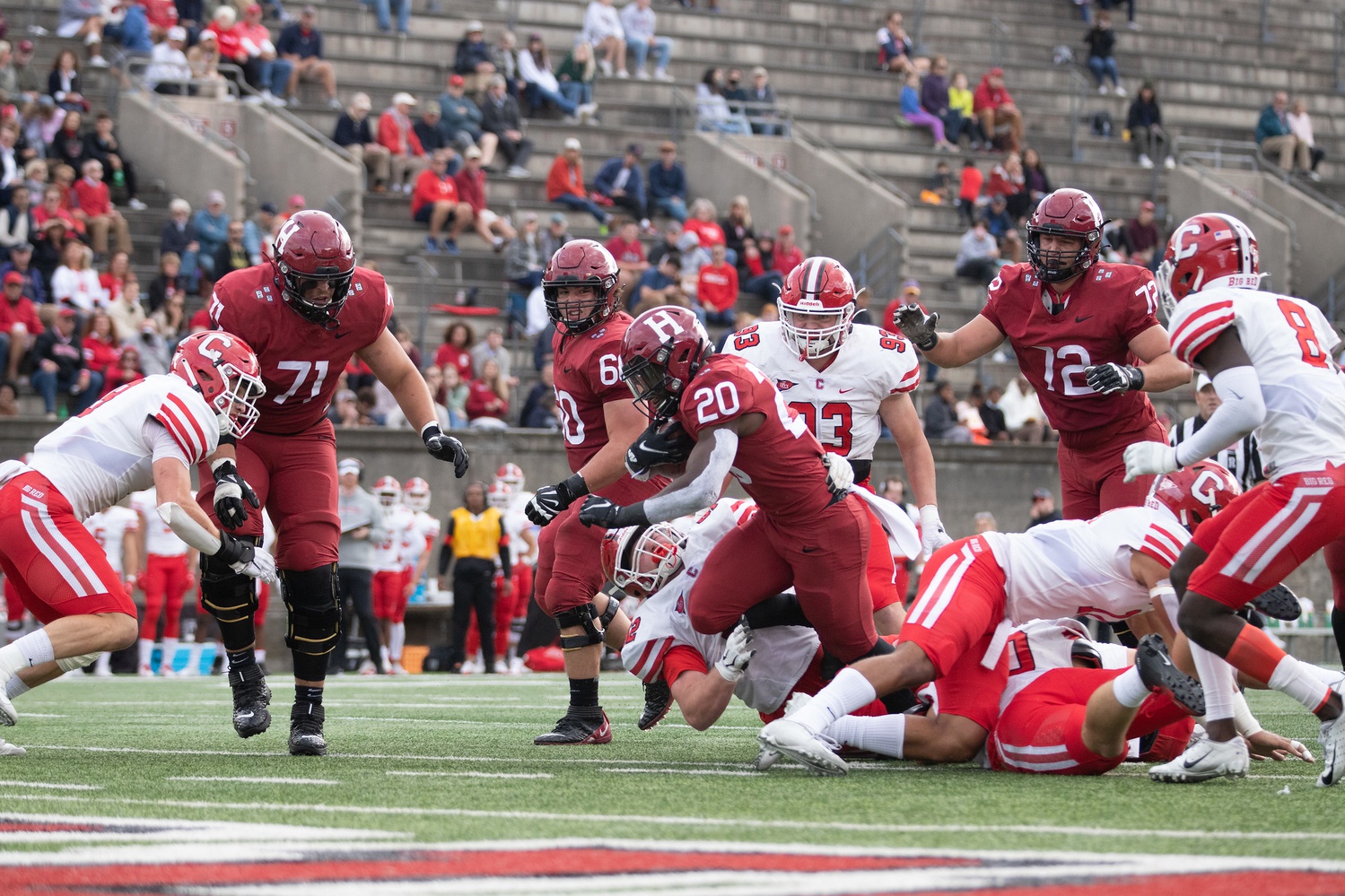 Junior running back Aaron Shampklin bursts through a line of Cornell defenders as he sets his sights on the goal line.