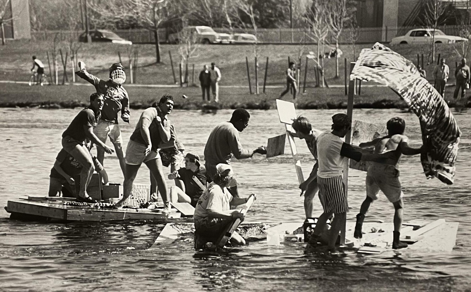 Student race across the Charles in makeshift rafts.