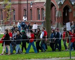 Demonstrators from Harvard Graduate Students Union cross the Yard
