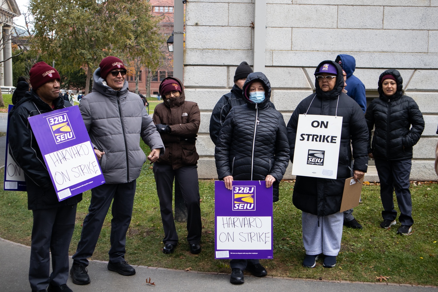 Custodians represented by the Service Employees International Union 32BJ picket outside University Hall.