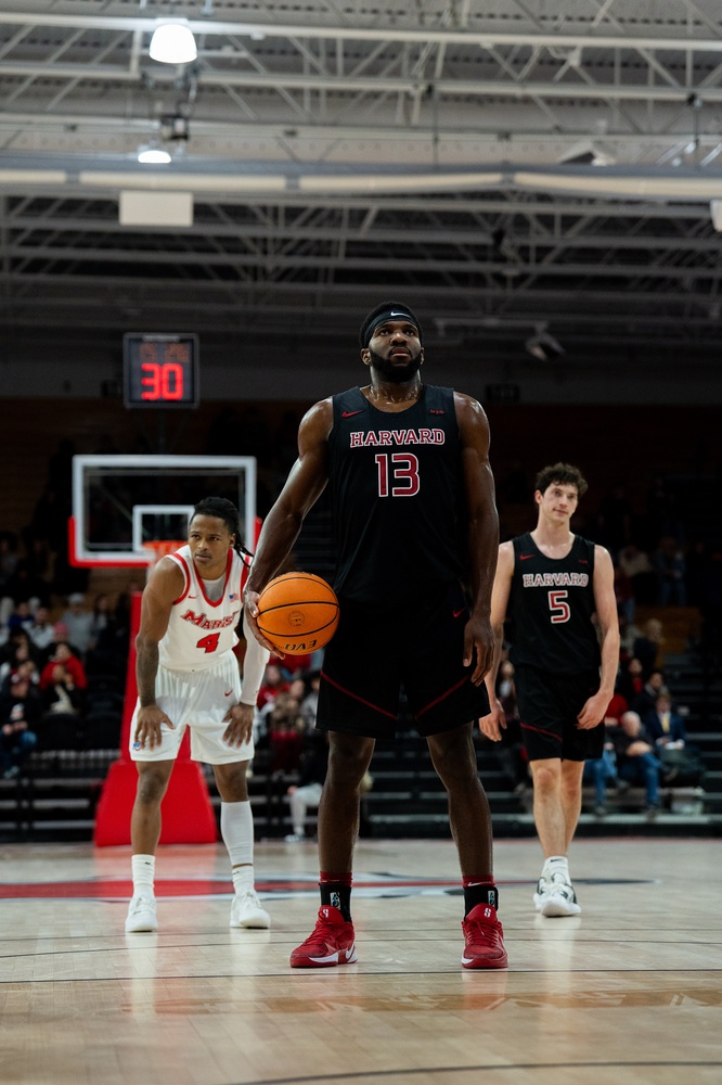 Harvard men's basketball captain and Crimson Sports Writer, Chandler Piggé, stares down the basket as he preps for a free throw in the team's game against Marist. 