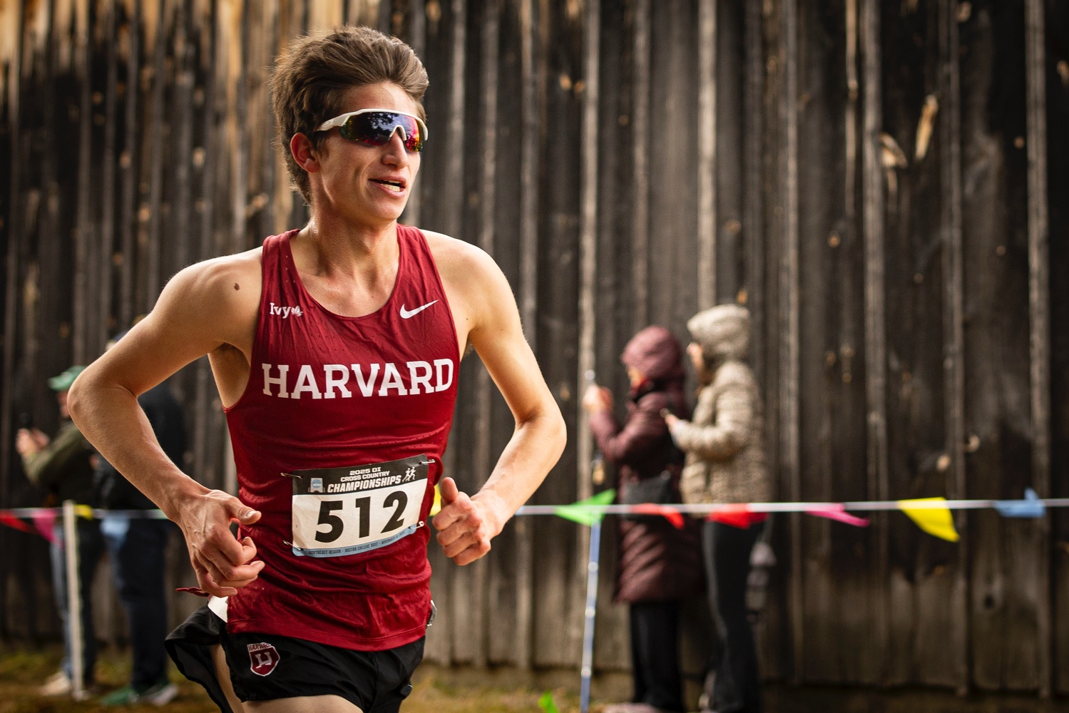 Sam Burgess races towards the finish line. The junior secured a third-place finish at the Northeast Regional Championships, helping the men's cross country team qualify for the NCAA Championships. 
