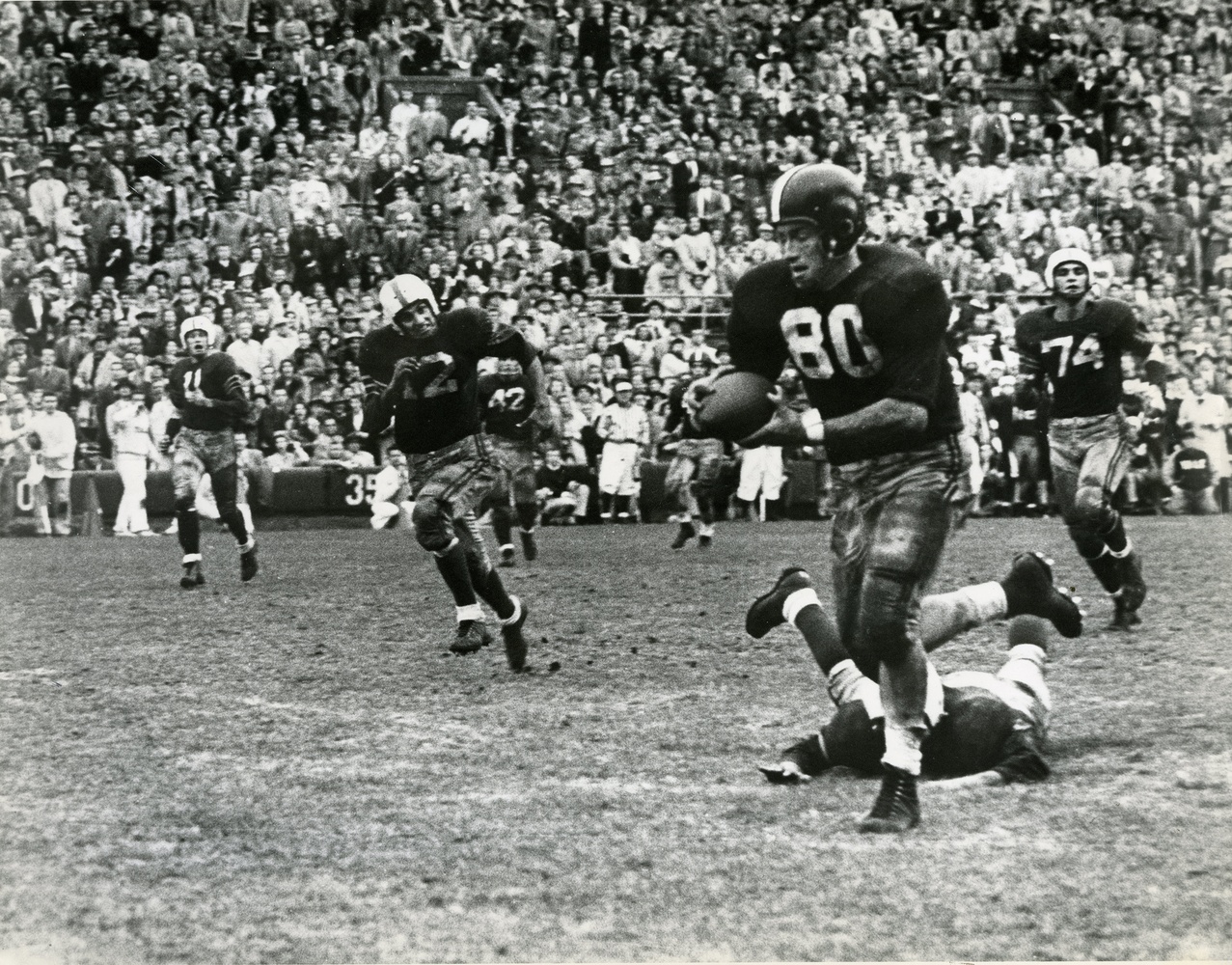 A Crimson receiver runs toward the end zone with the ball during an earlier rendition of The Game.