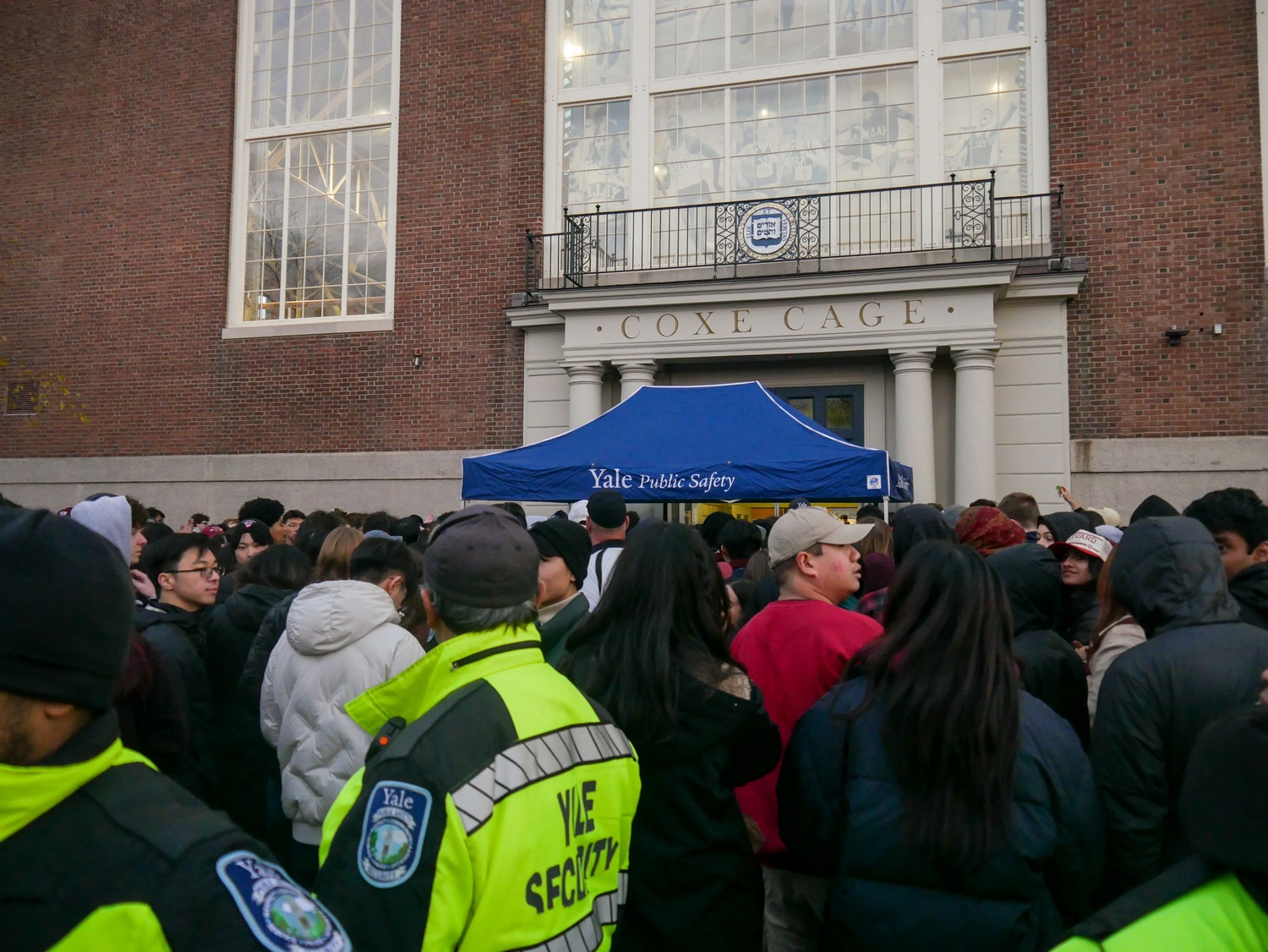 Attendees of the 141st Harvard-Yale Game faced dense crowds to pick up their bags from a checkpoints outside Coxe Cage, home to Yale's indoor track facilities.